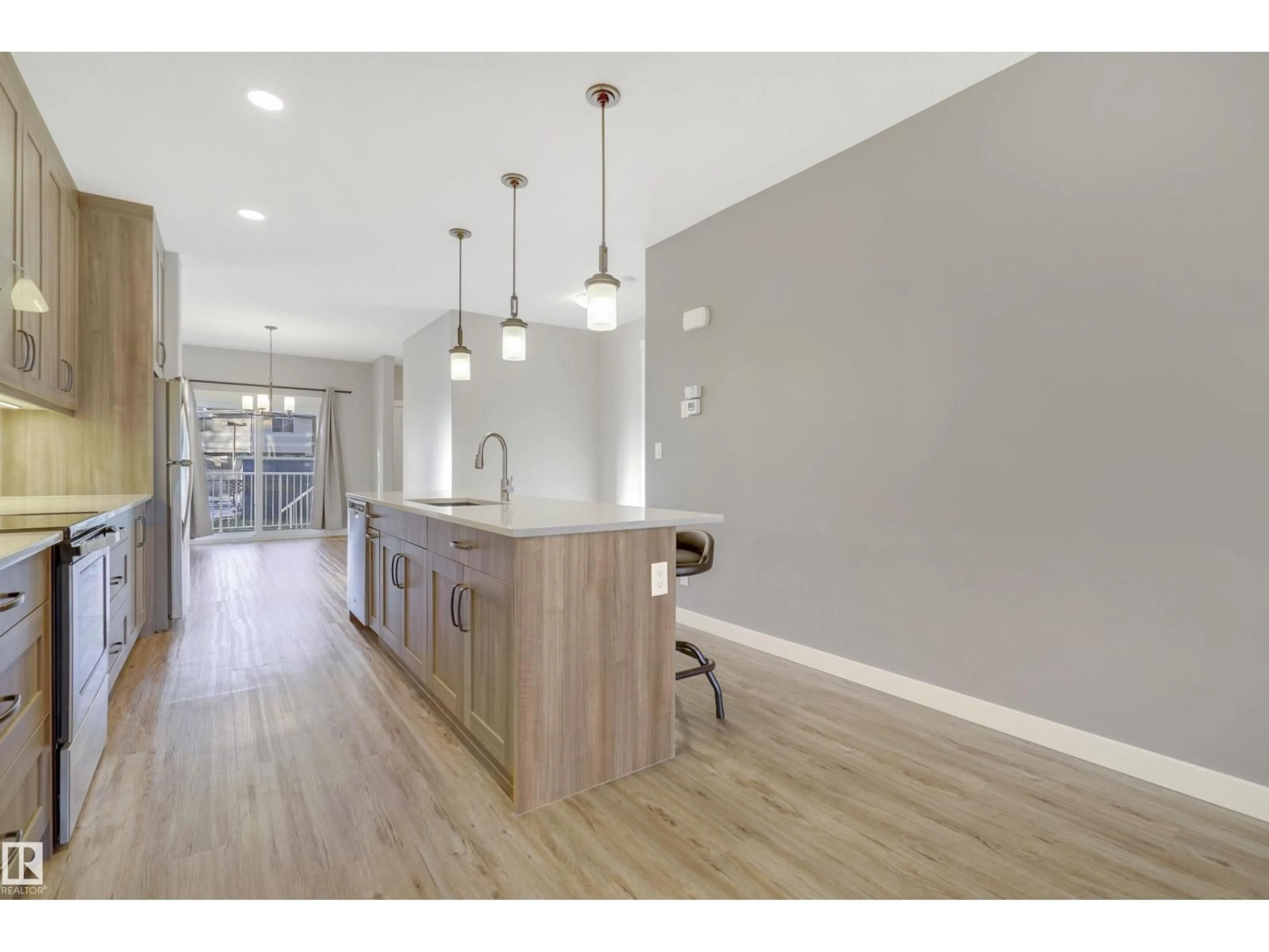 Open concept kitchen, wood/laminate floor for 8540 89 ST, Edmonton Alberta T6C3K3