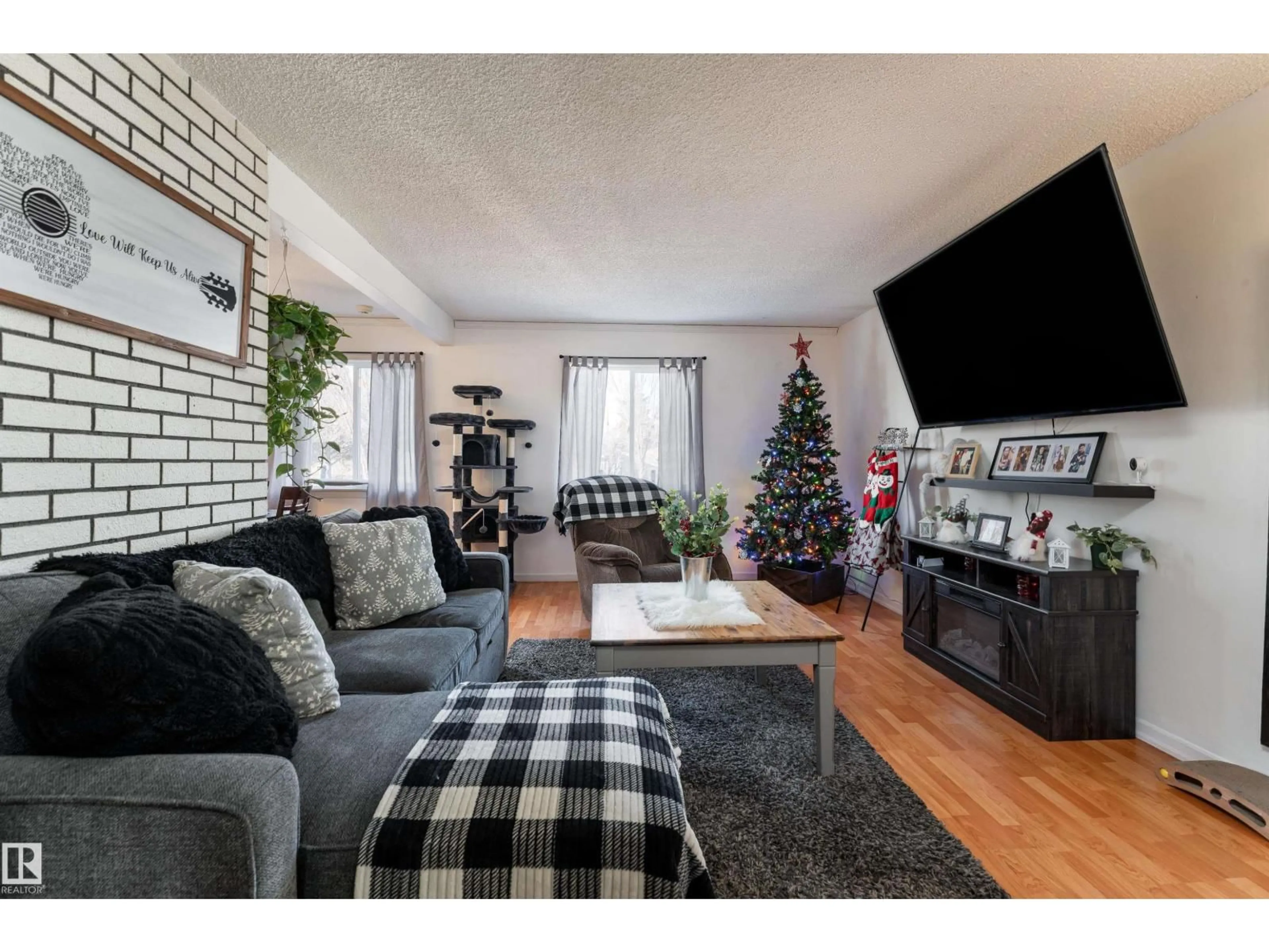 Living room with furniture, wood/laminate floor for NW - 8207 169 ST, Edmonton Alberta T5R2W4