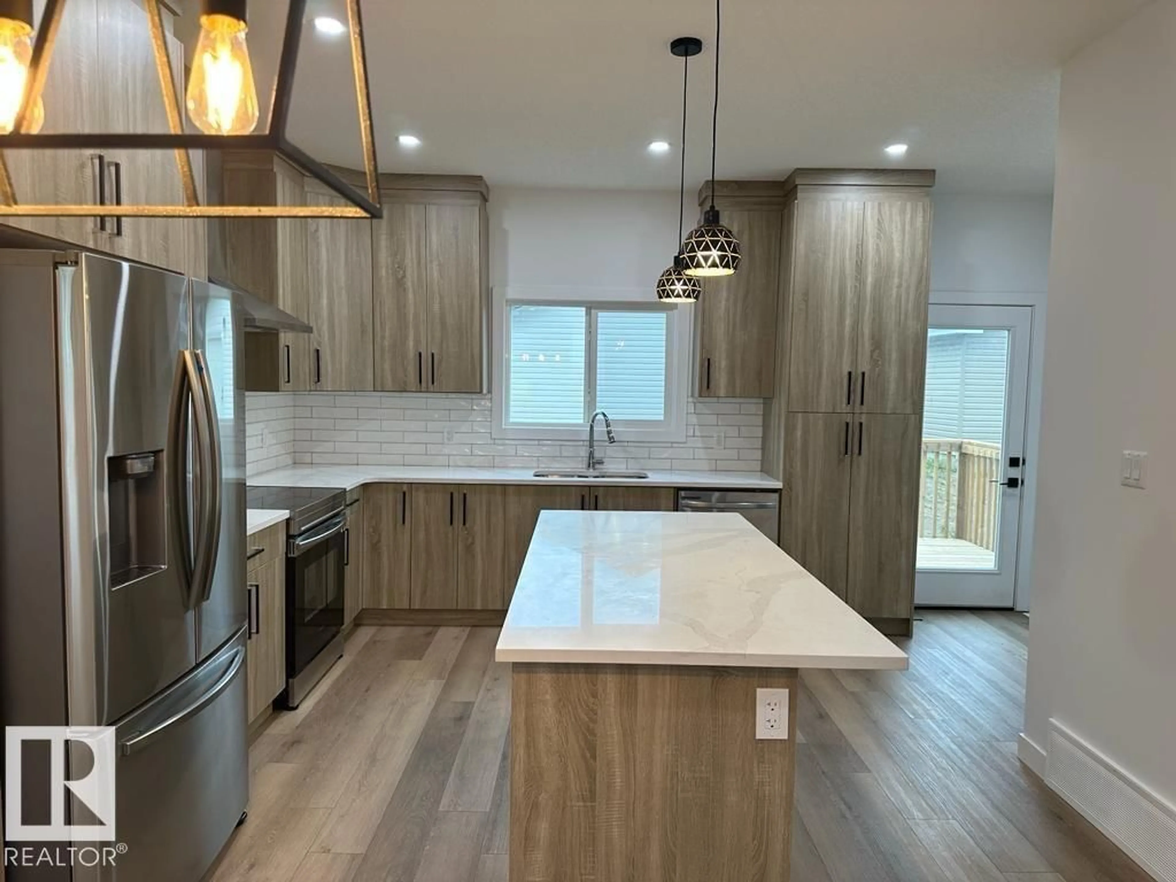 Open concept kitchen, wood/laminate floor for 6079 180 AV, Edmonton Alberta T5Y3X1