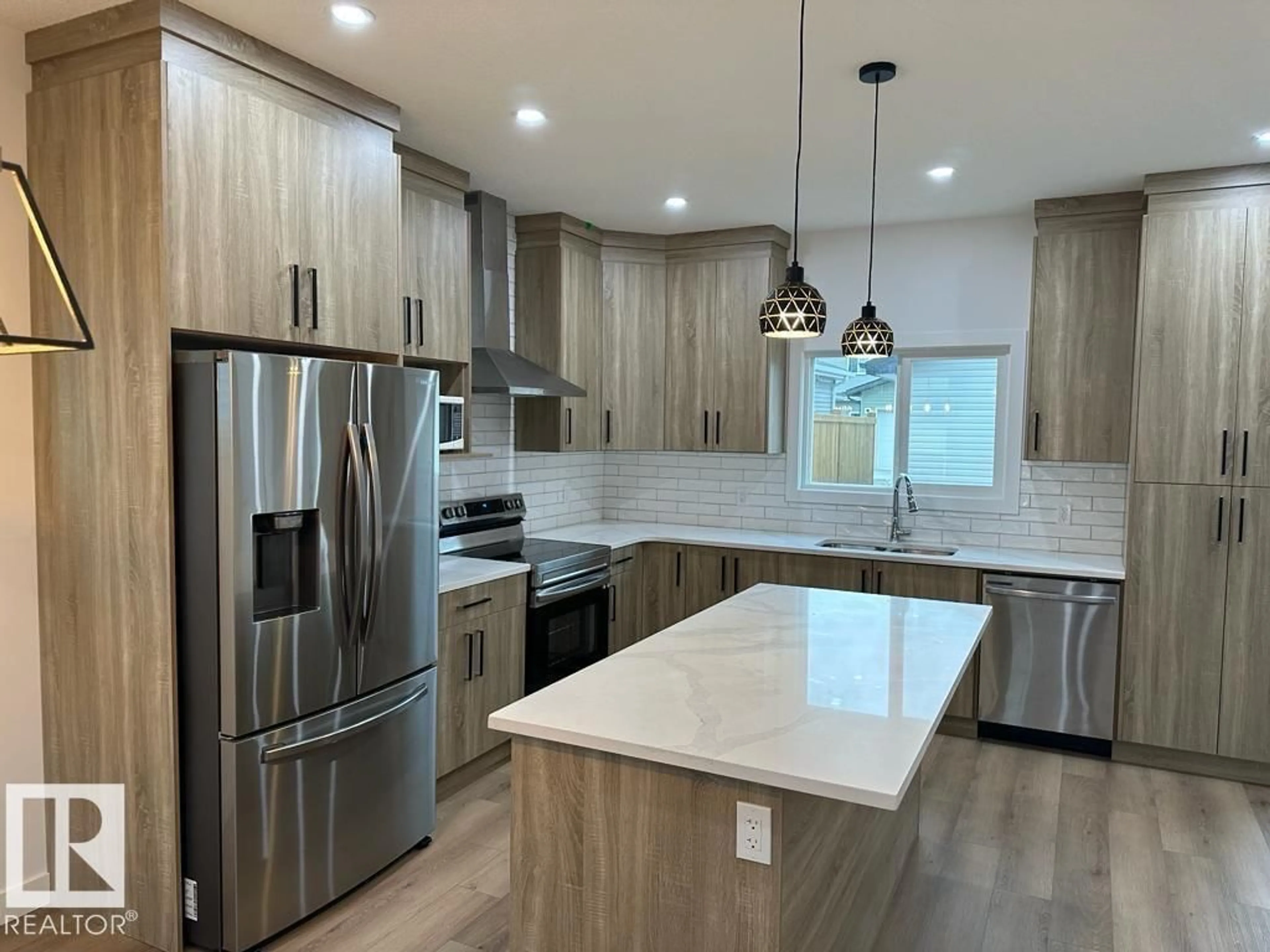 Open concept kitchen, wood/laminate floor for 6079 180 AV, Edmonton Alberta T5Y3X1