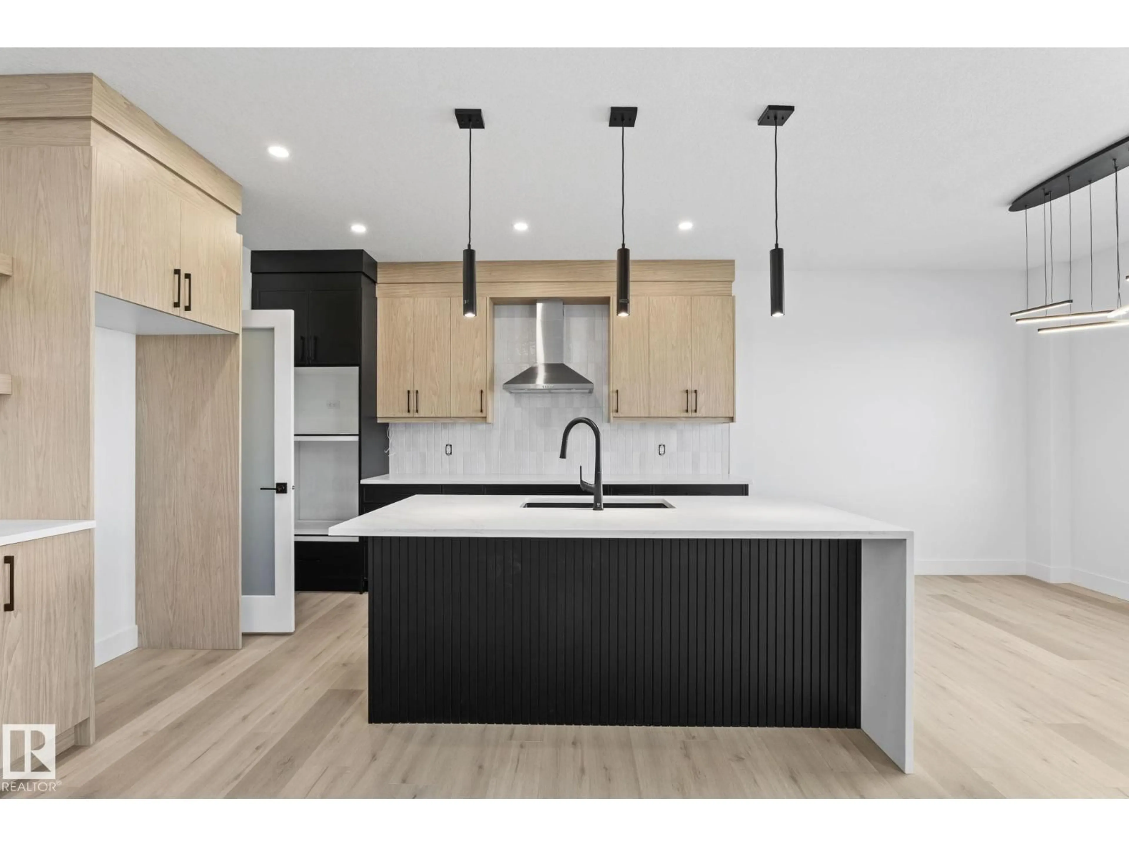 Open concept kitchen, wood/laminate floor for 8512 181 AV, Edmonton Alberta T5Z0X1