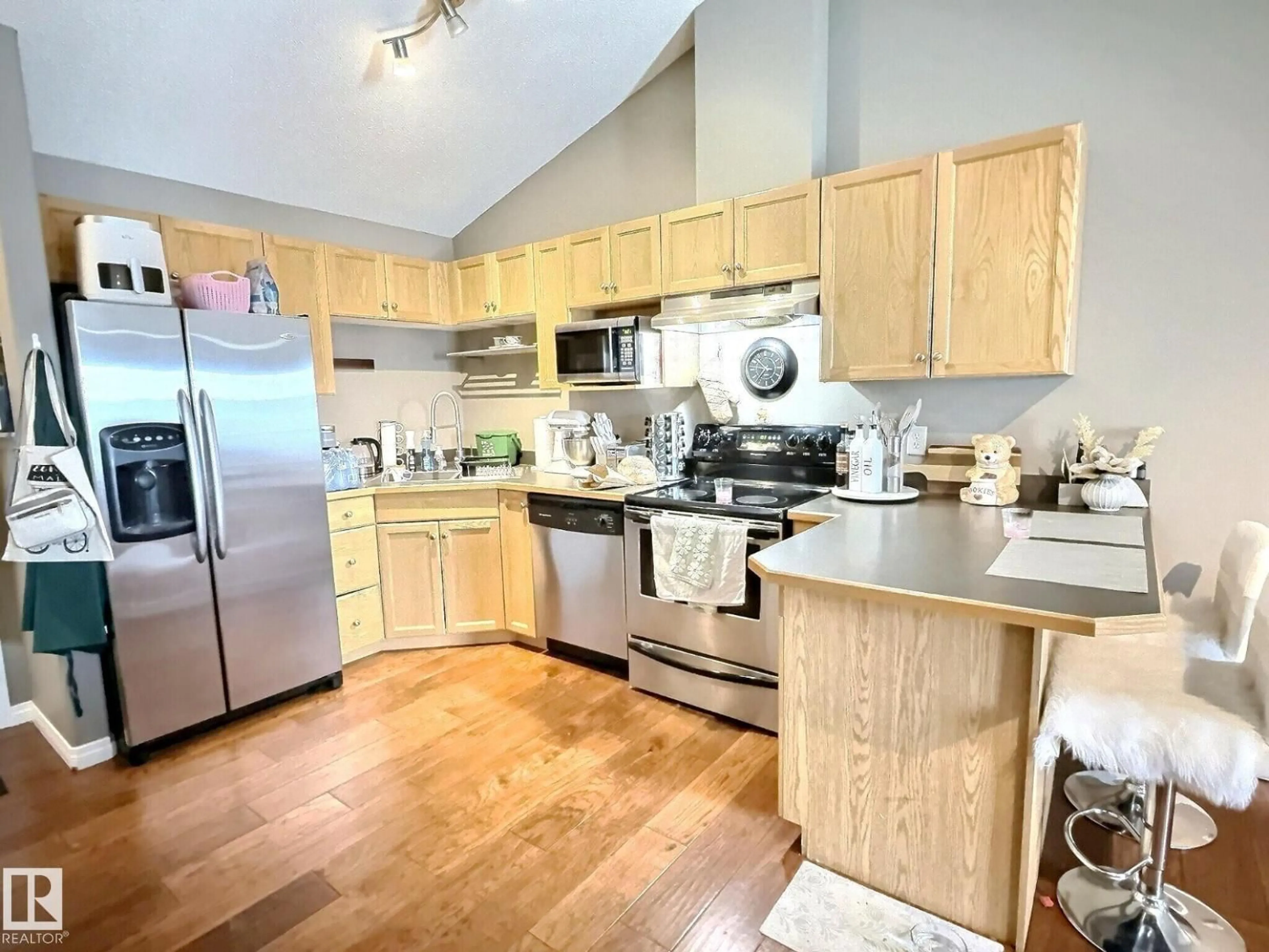 Open concept kitchen, wood/laminate floor for #318 - 9525 162 AV, Edmonton Alberta T5Z3V2