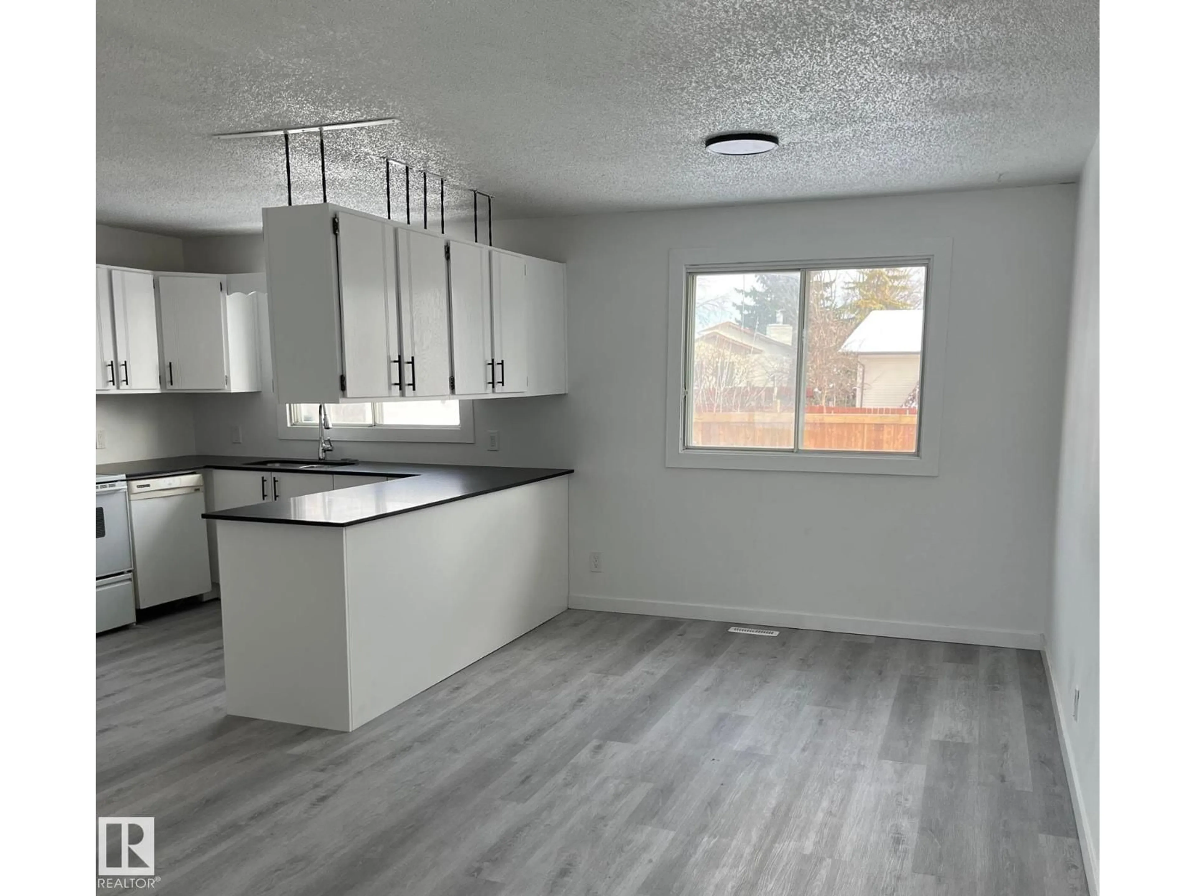Open concept kitchen, wood/laminate floor for 4315 42 ST, Bonnyville Town Alberta T9N1W6