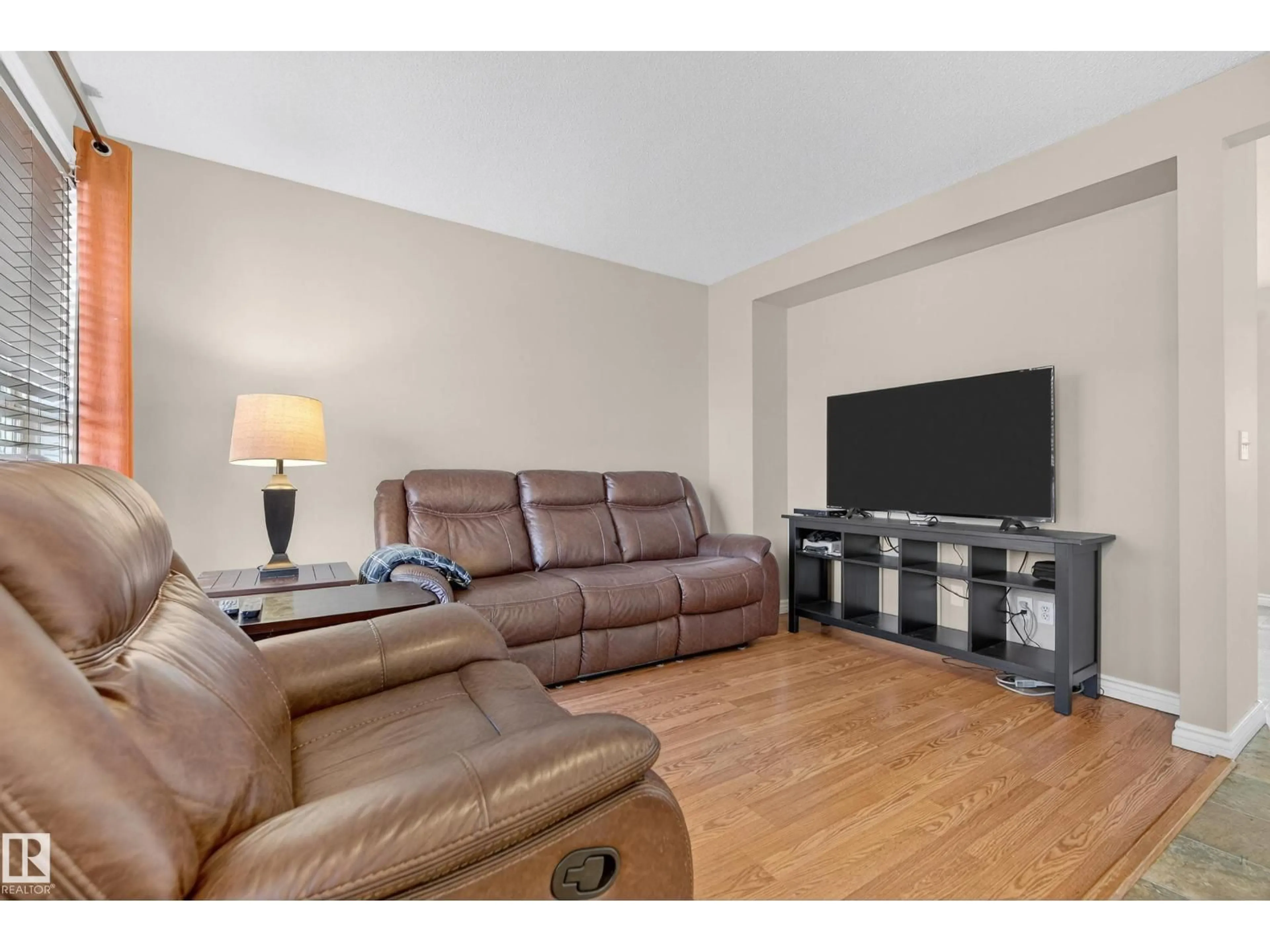 Living room with furniture, wood/laminate floor for 75 ERIE ST, Devon Alberta T9G2G3