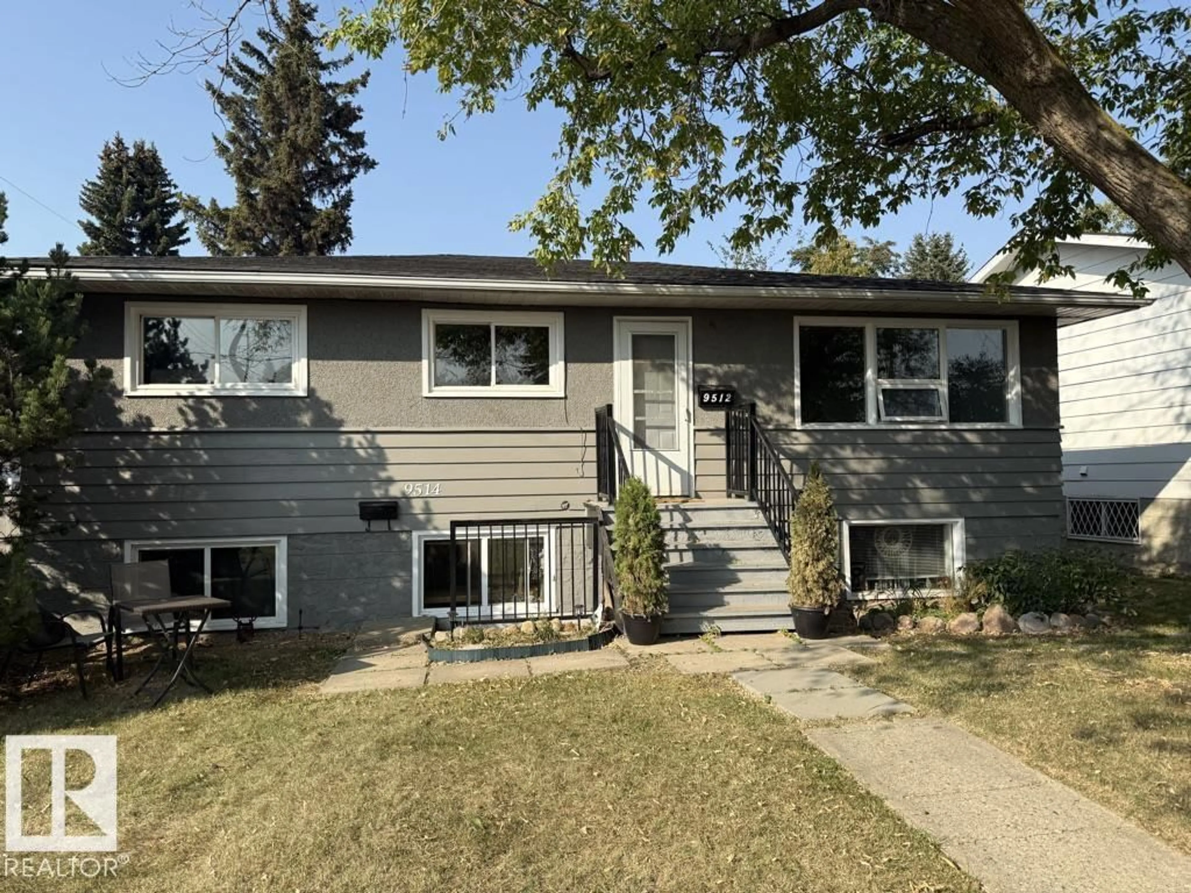 Home with vinyl exterior material, street for 9512/9514 128 AV, Edmonton Alberta T5E0H6