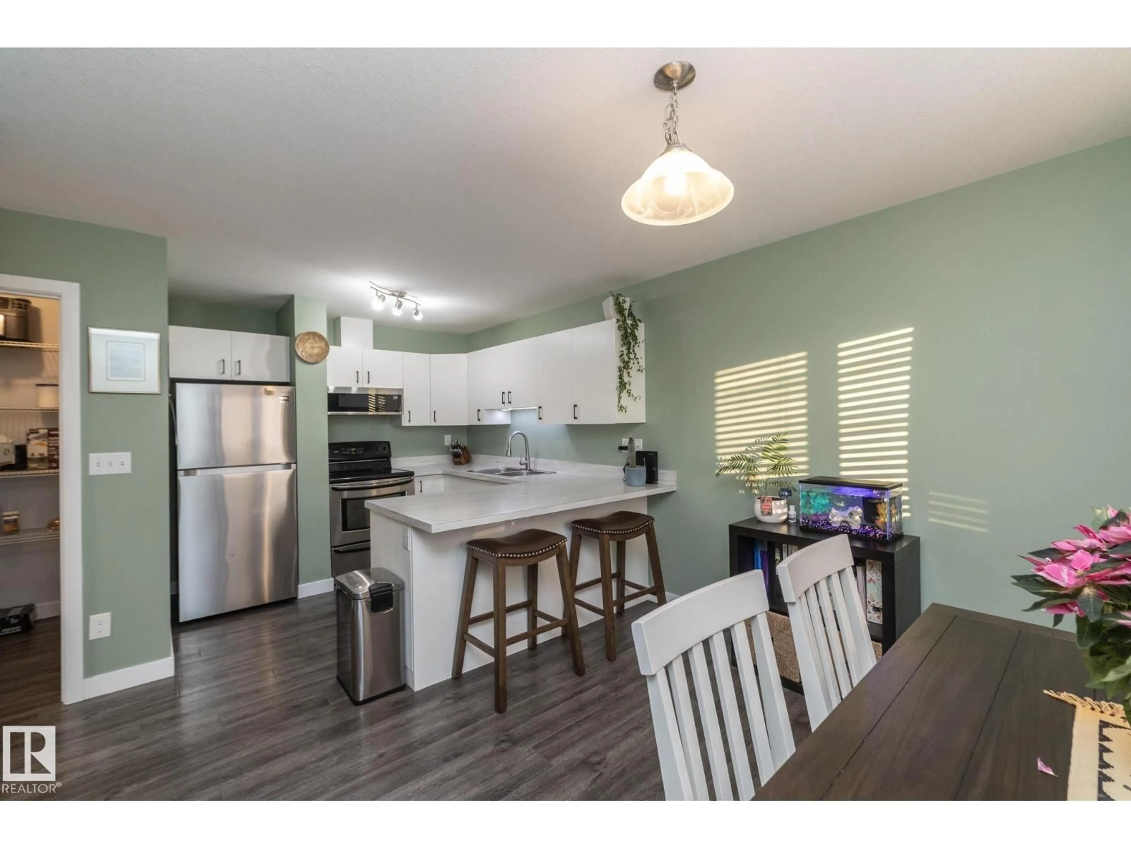 Open concept kitchen, wood/laminate floor for B - 10018 99 ST, Morinville Alberta T8R1B3