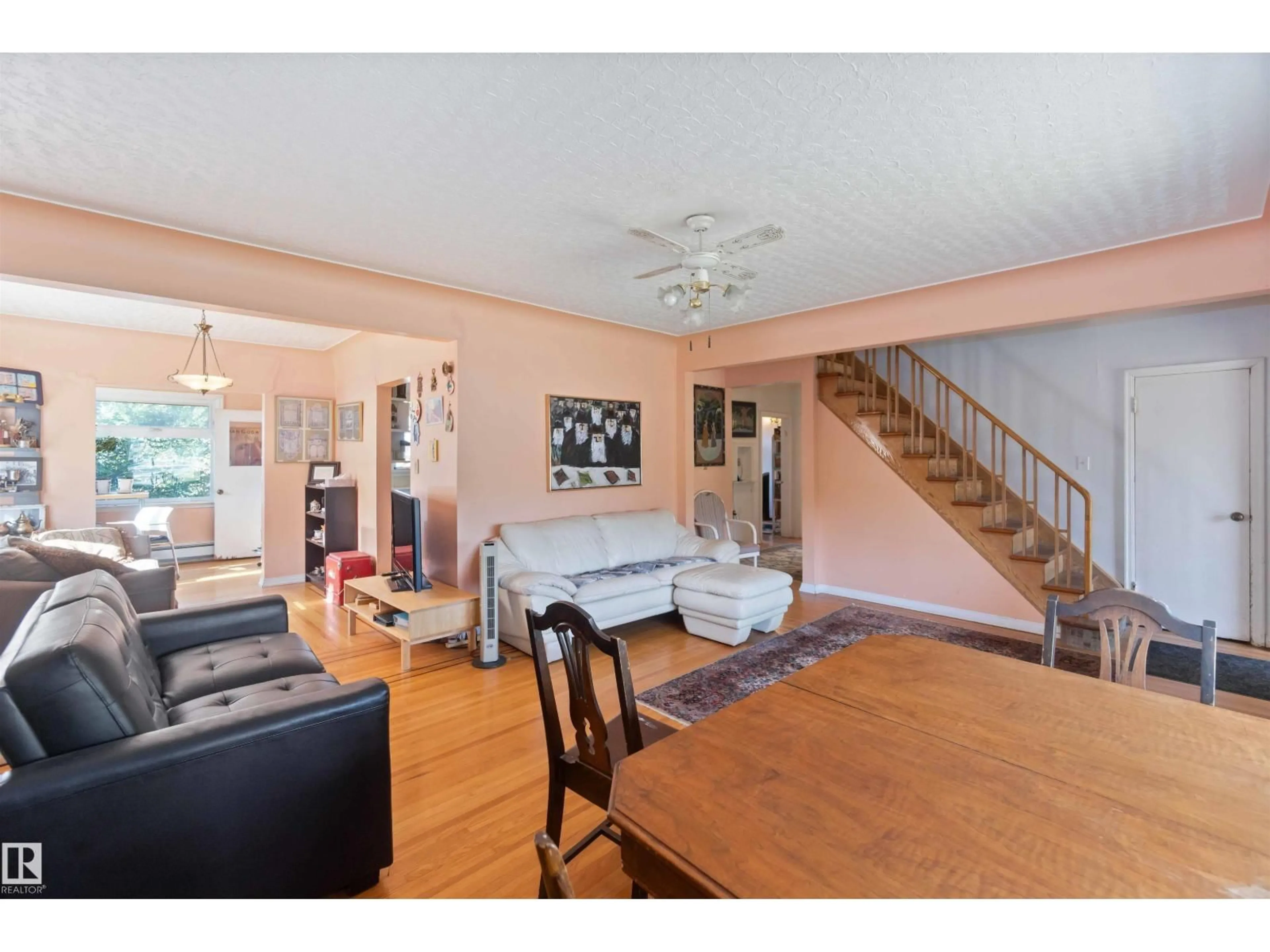 Living room with furniture, wood/laminate floor for NW - 11022 110 AV, Edmonton Alberta T5H1H9