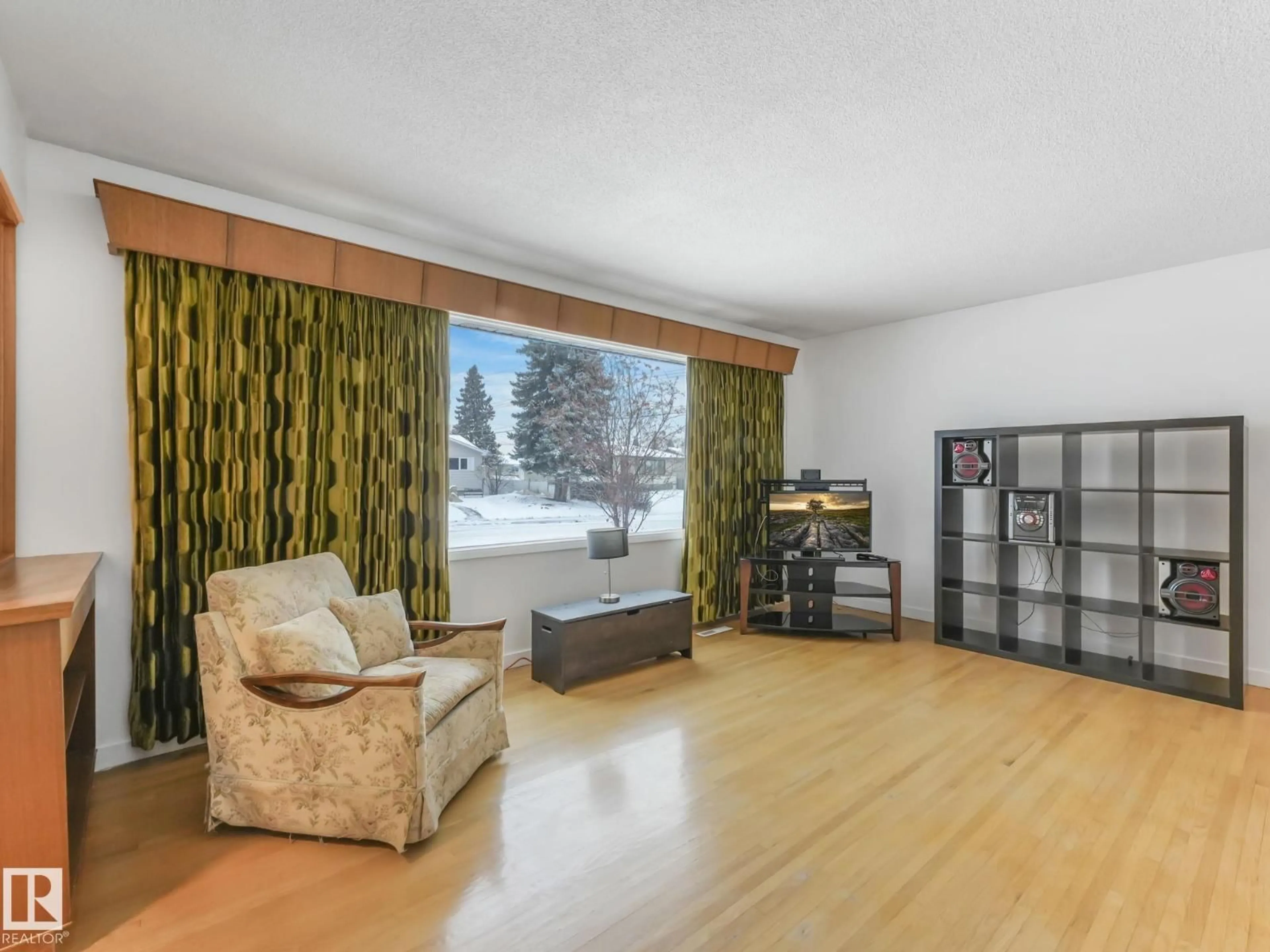 Living room with furniture, wood/laminate floor for 11412 134A AV, Edmonton Alberta T5E1M6