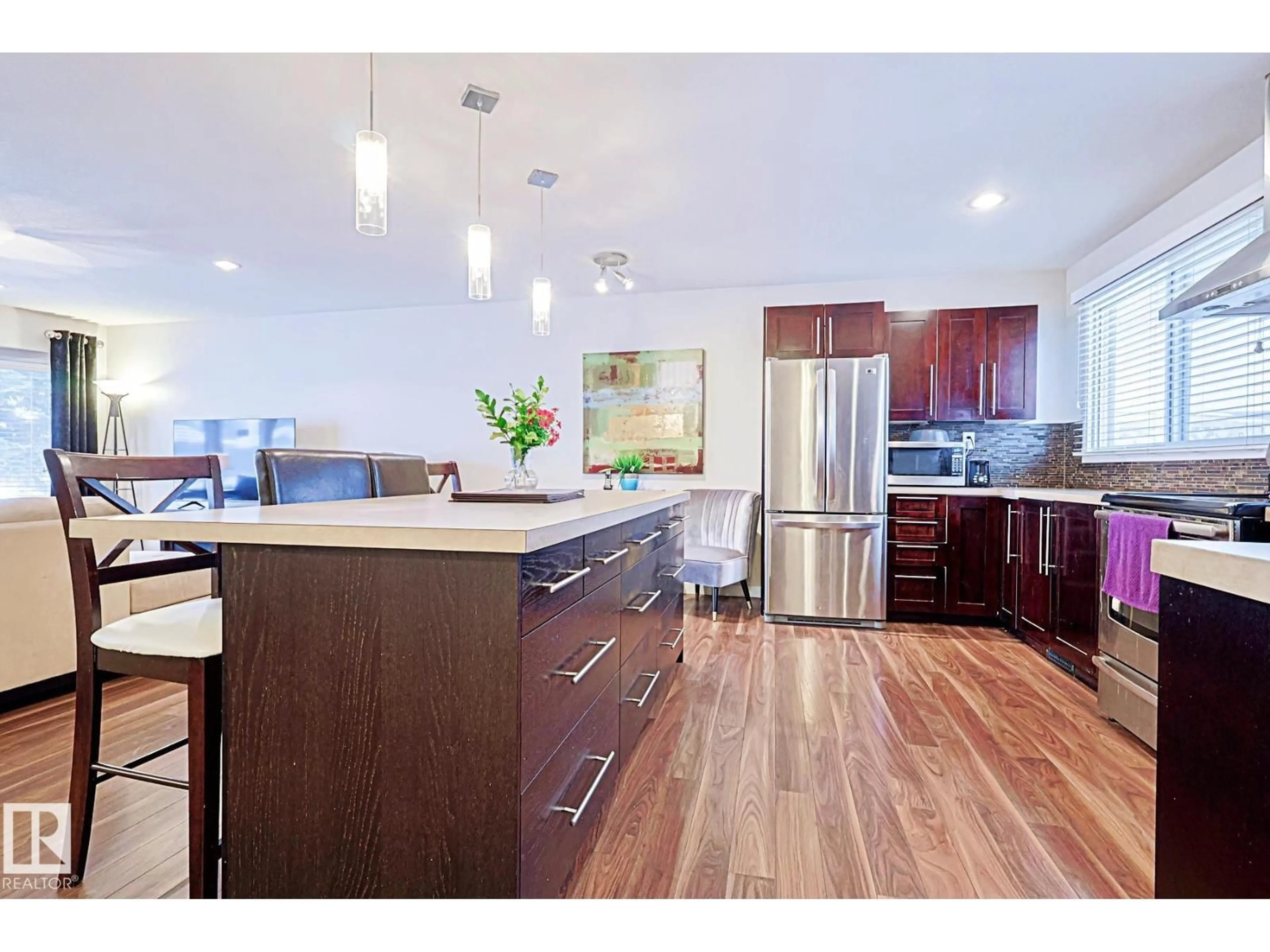 Open concept kitchen, wood/laminate floor for 5518 11A AV, Edmonton Alberta T6L2A9