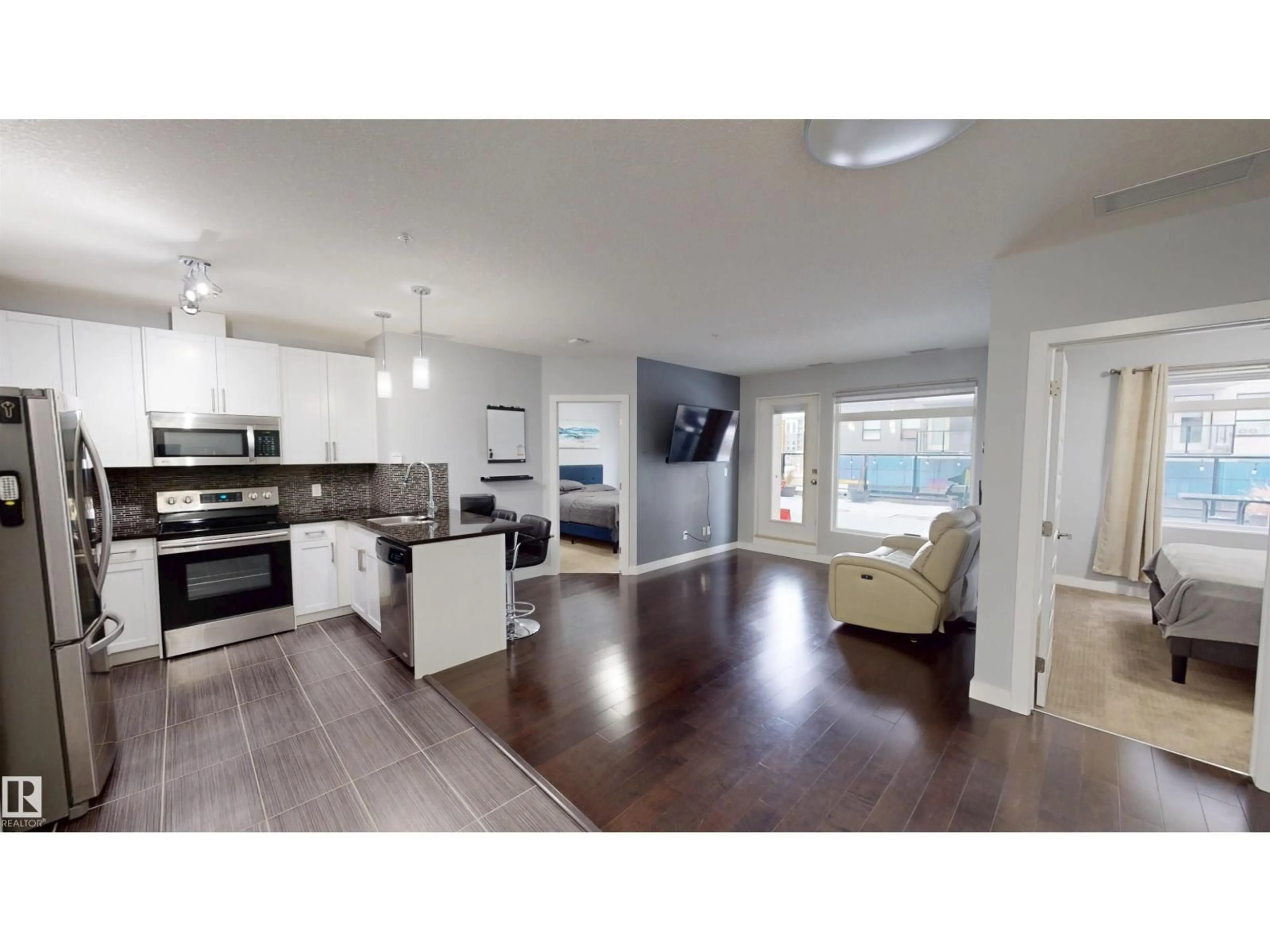 Open concept kitchen, wood/laminate floor for #212 - 5151 WINDERMERE BV, Edmonton Alberta T6W2K4