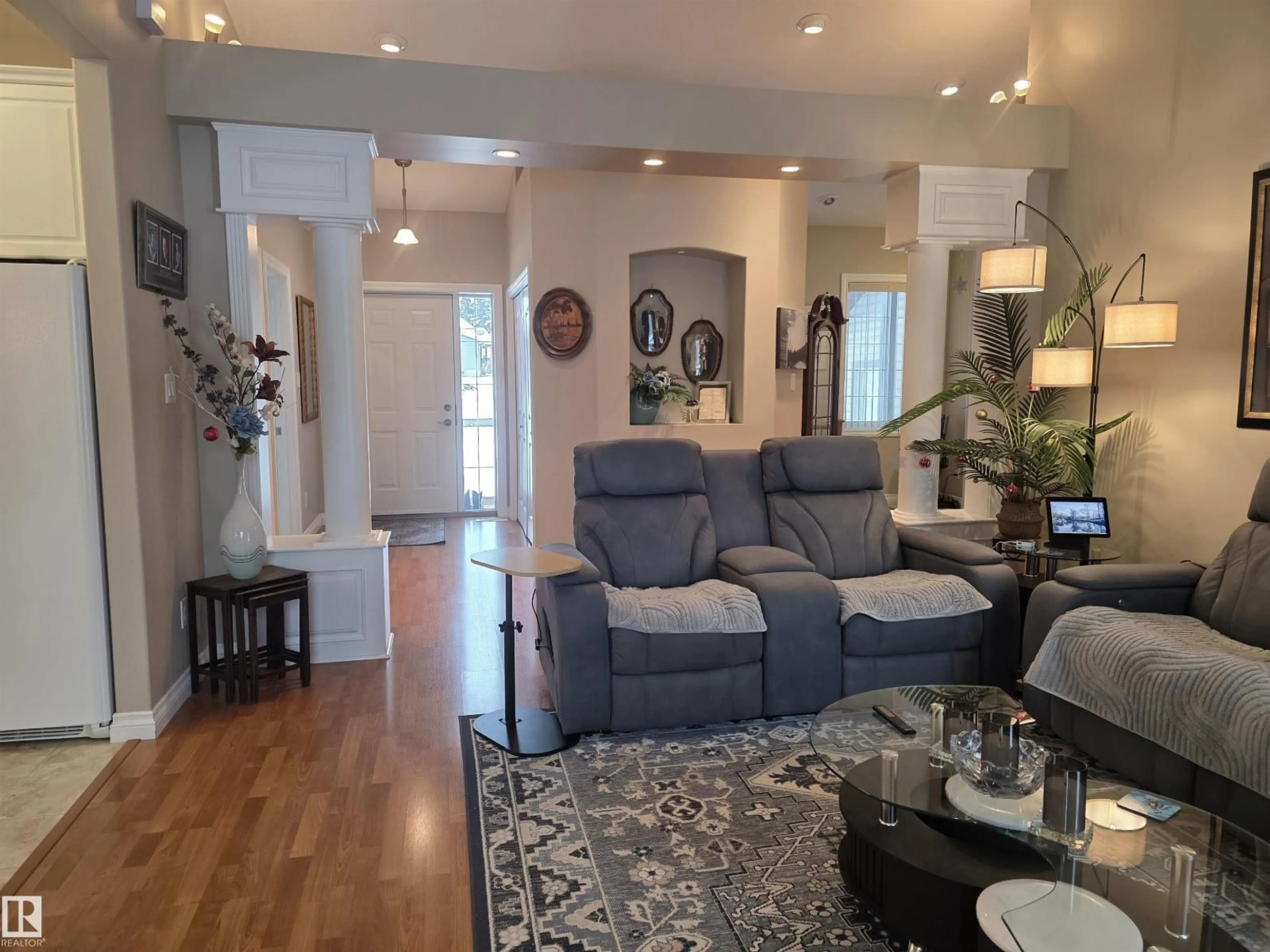 Living room with furniture, wood/laminate floor for 185 WILLOW DR, Breton Alberta T0C0P0