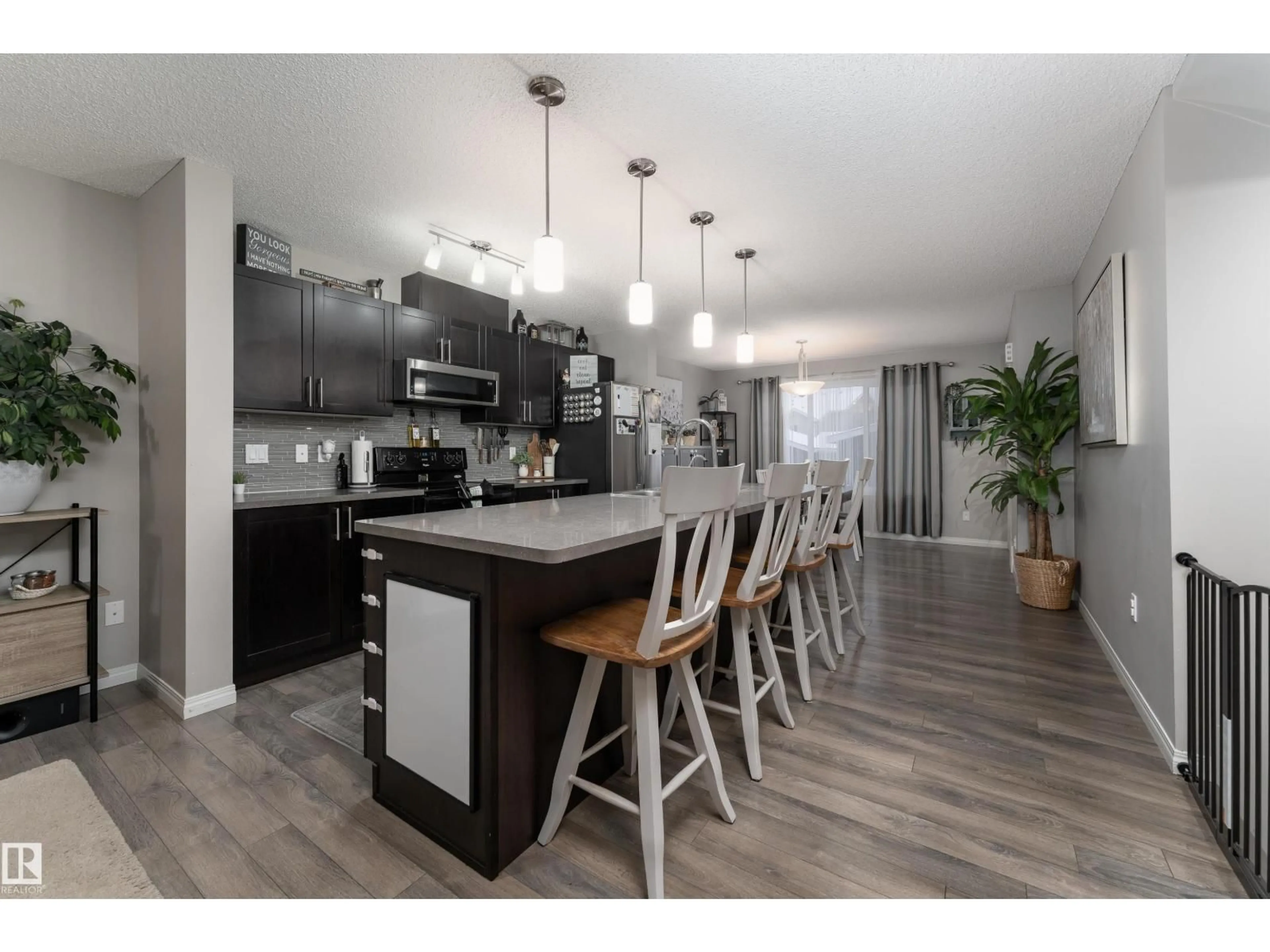 Open concept kitchen, wood/laminate floor for 8533 ELLIS LI, Edmonton Alberta T6M0P5