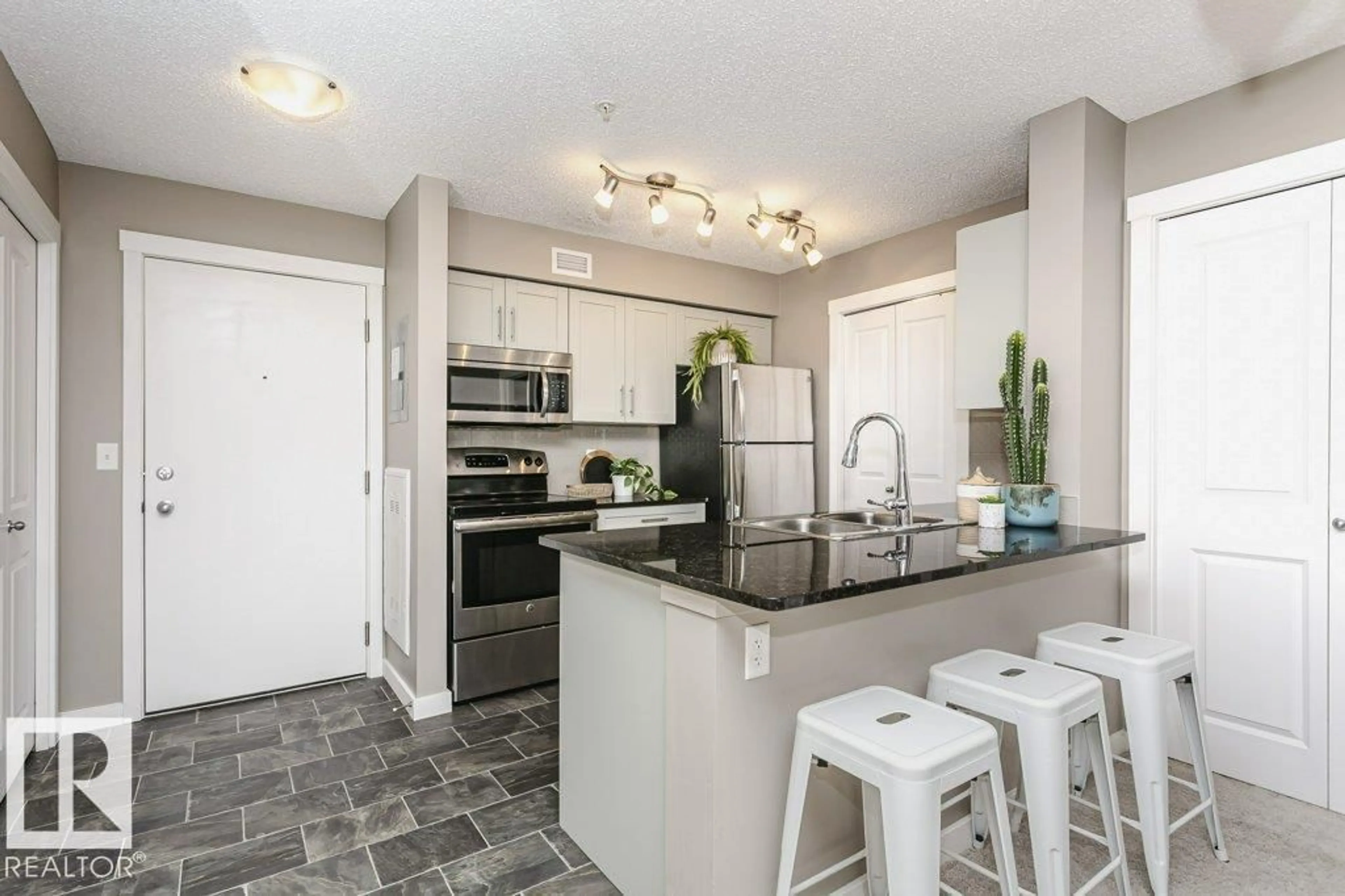 Open concept kitchen, ceramic/tile floor for 106 - 5816 MULLEN PL, Edmonton Alberta T6R0W3