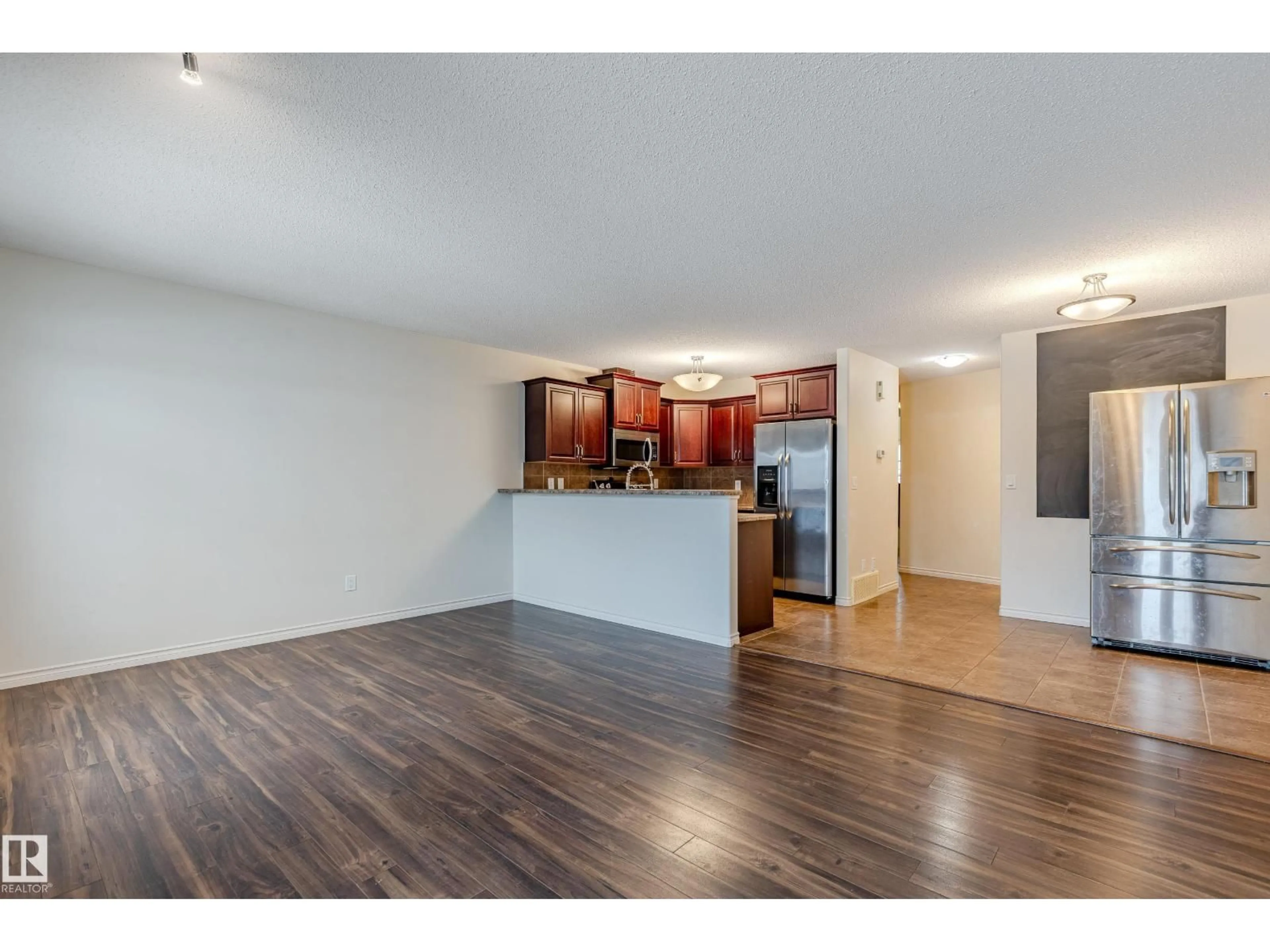 Open concept kitchen, wood/laminate floor for 28 - 9511 102 AVE, Morinville Alberta T8R0C6