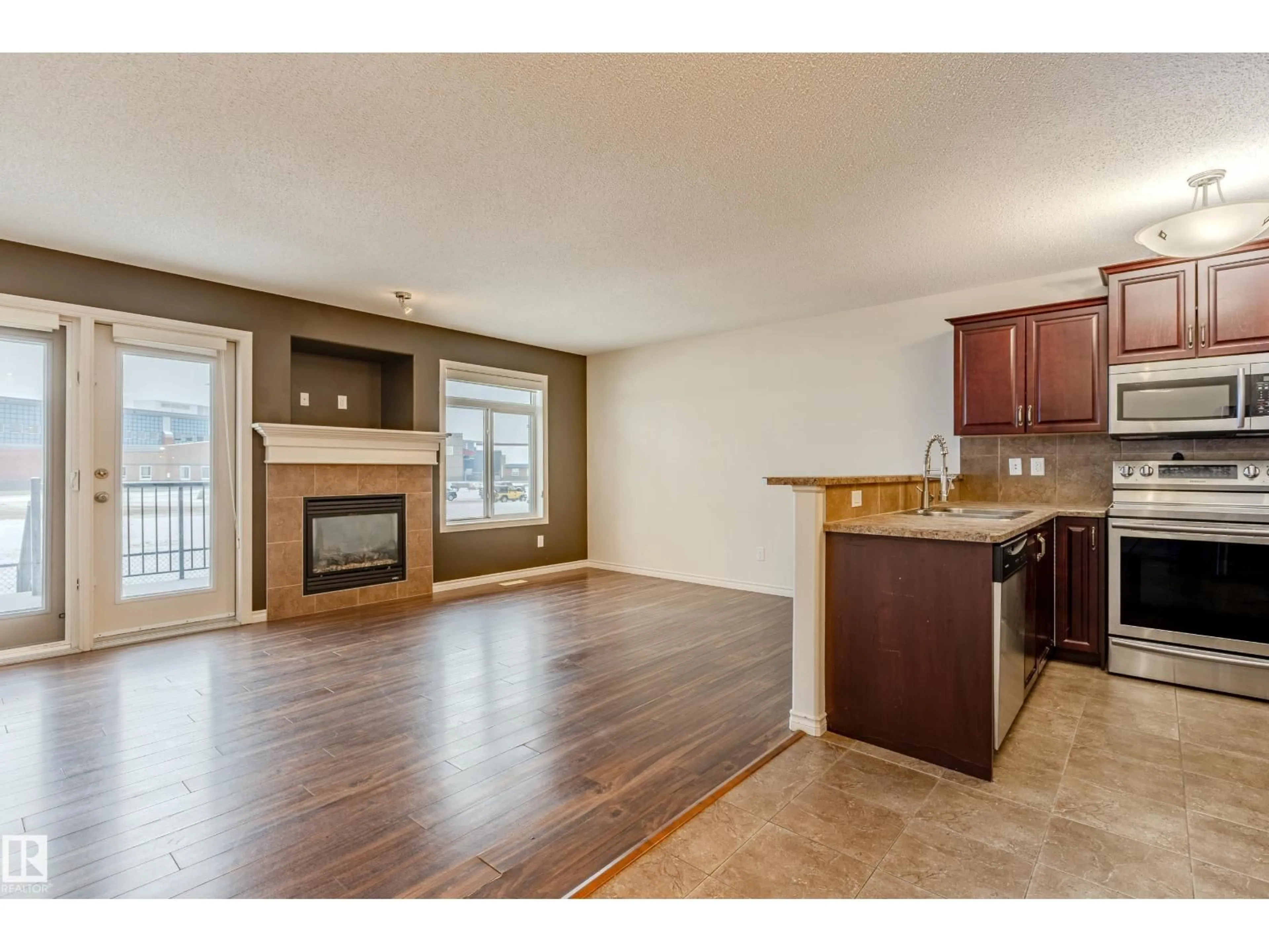 Open concept kitchen, wood/laminate floor for 28 - 9511 102 AVE, Morinville Alberta T8R0C6