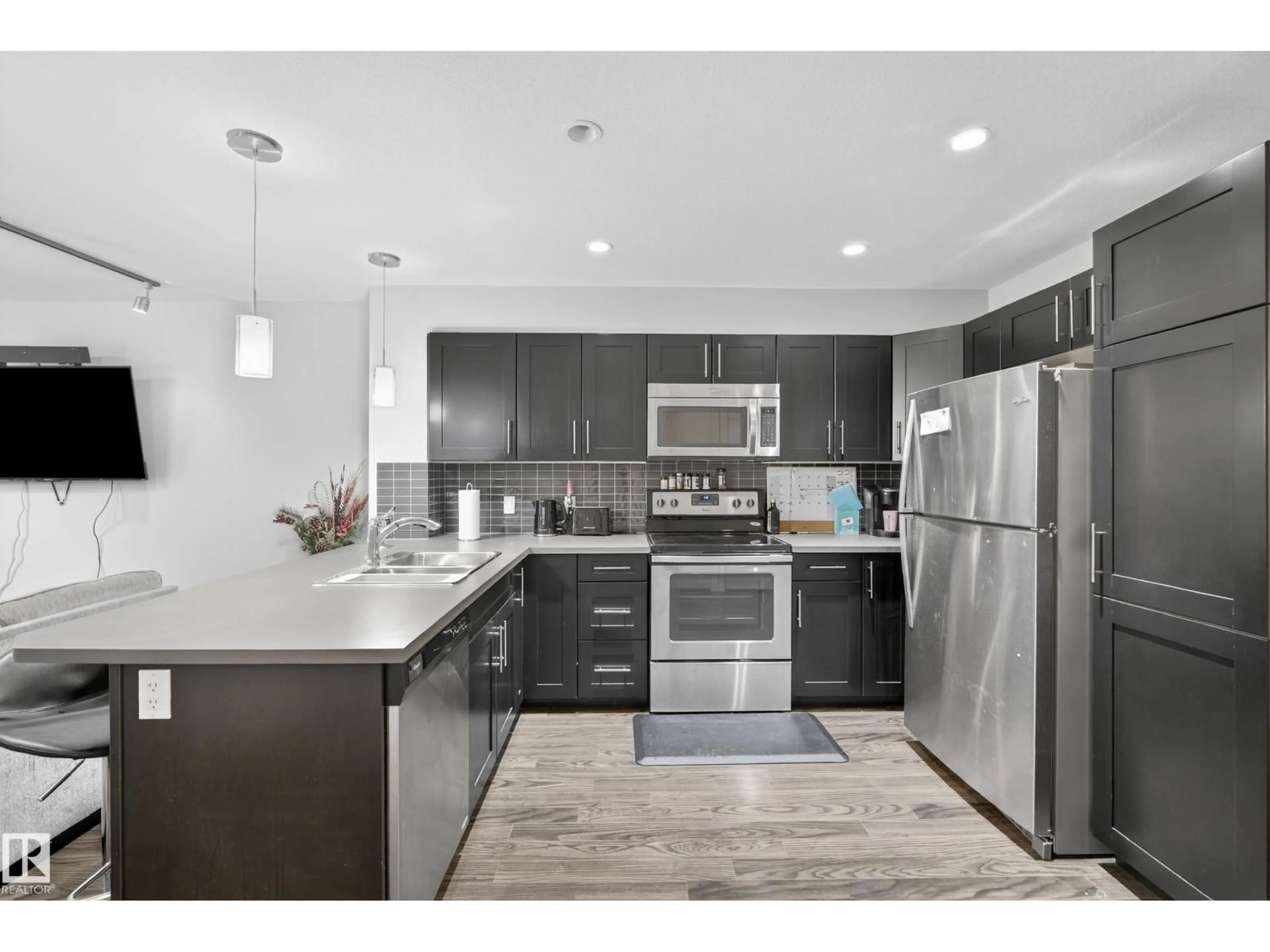 Open concept kitchen, unknown for #107 - 1031 173 ST, Edmonton Alberta T6W3E4
