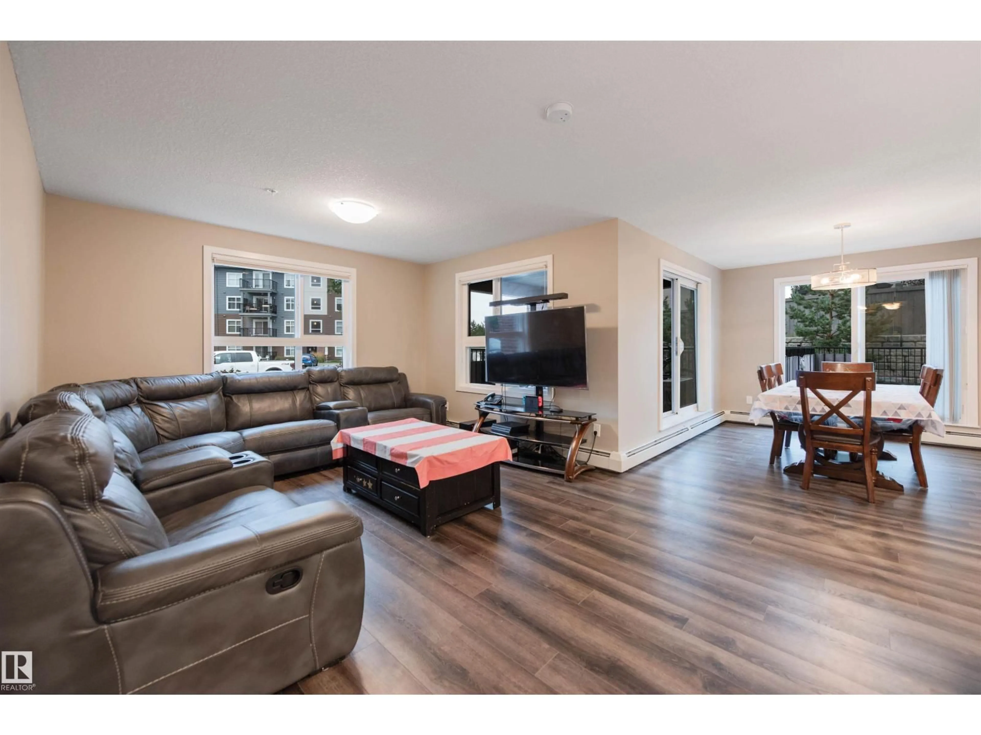 Living room with furniture, wood/laminate floor for 5504 - 121 SCHONSEE DR, Edmonton Alberta T5Z0N9