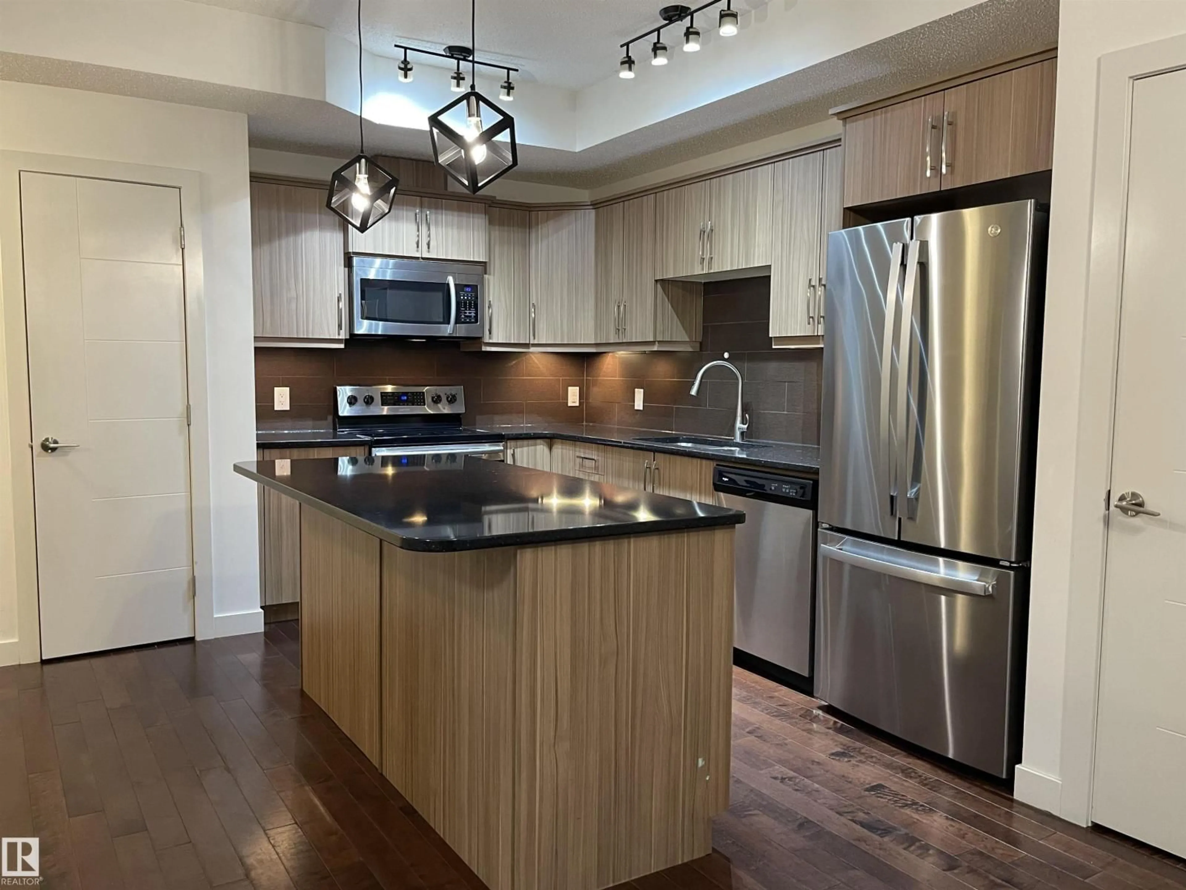 Open concept kitchen, wood/laminate floor for #115 - 10523 123 ST, Edmonton Alberta T5N1N9