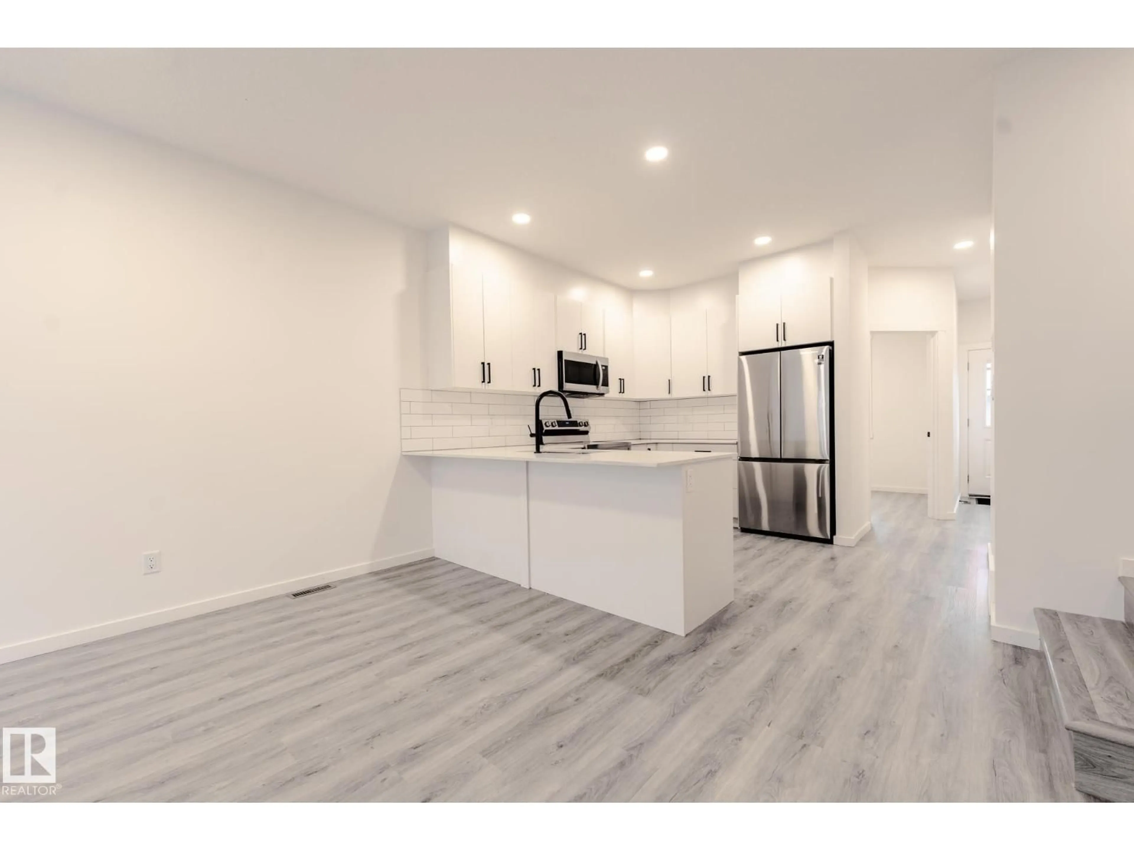 Open concept kitchen, wood/laminate floor for 1213 PODERSKY WD, Edmonton Alberta T6W4W3