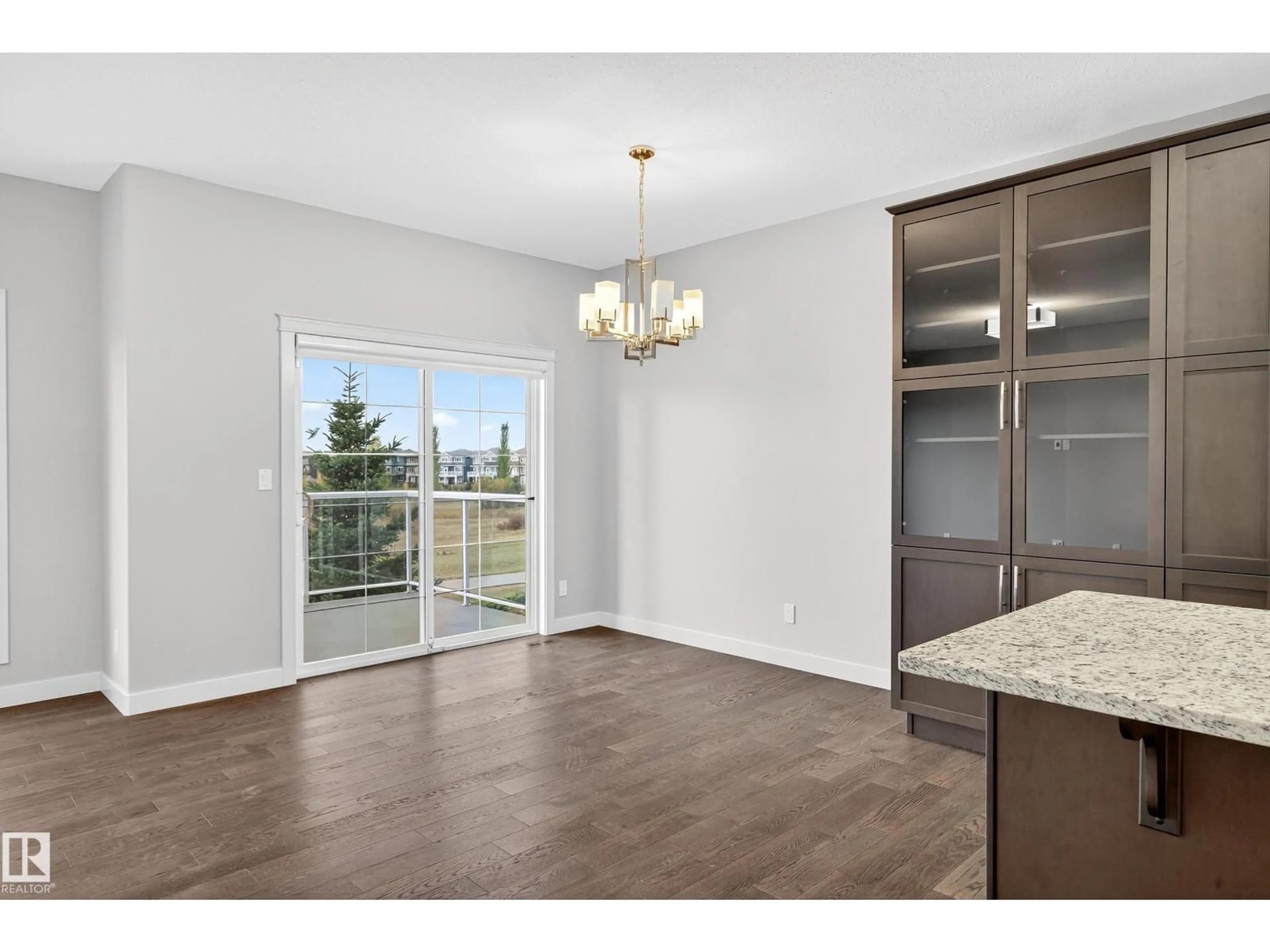 Open concept kitchen, wood/laminate floor for #13 - 8132 217 ST NW, Edmonton Alberta T5T4S1