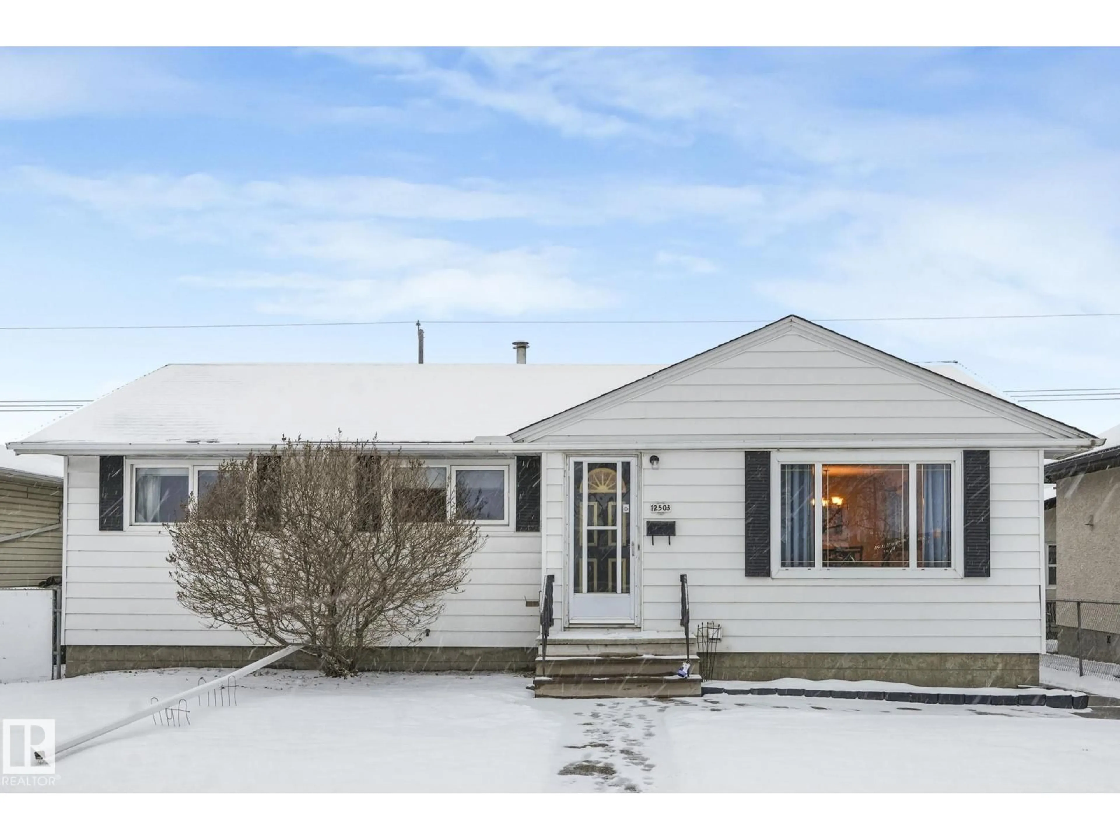 Home with vinyl exterior material, street for 12503 137 AV, Edmonton Alberta T5L4C2