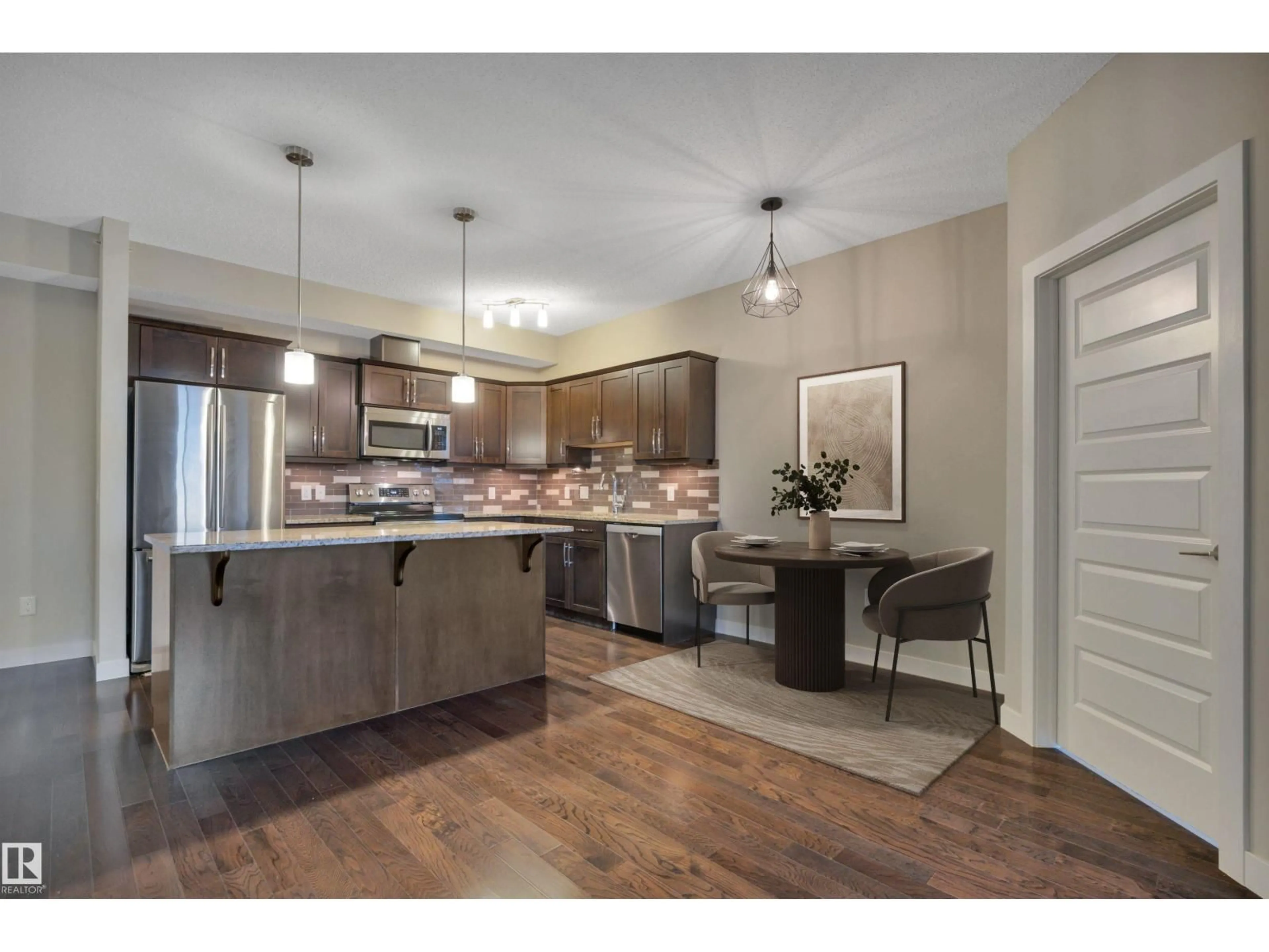 Open concept kitchen, wood/laminate floor for 409 - 10520 56 AV, Edmonton Alberta T6H0X7