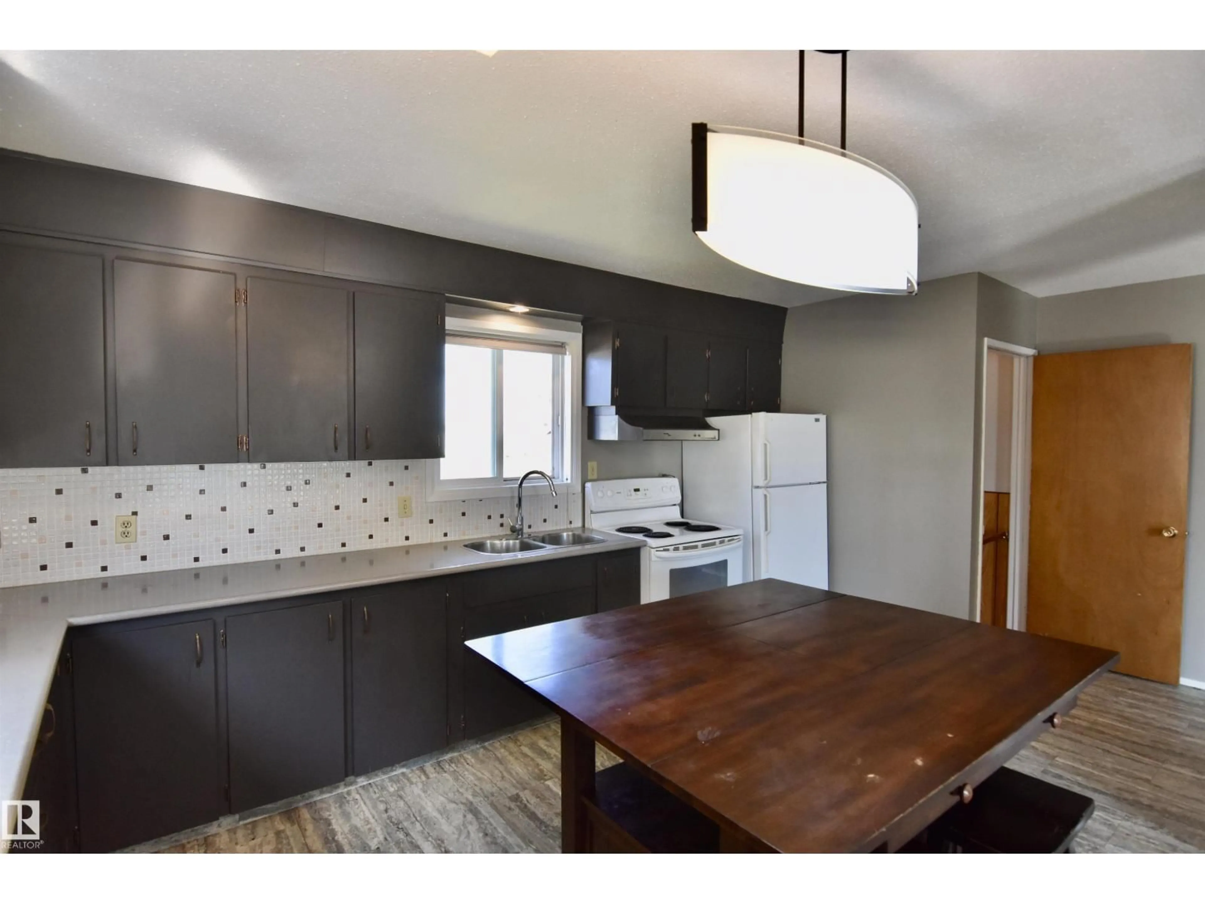 Open concept kitchen, wood/laminate floor for 4930 44 AV, St. Paul Town Alberta T0A3A4