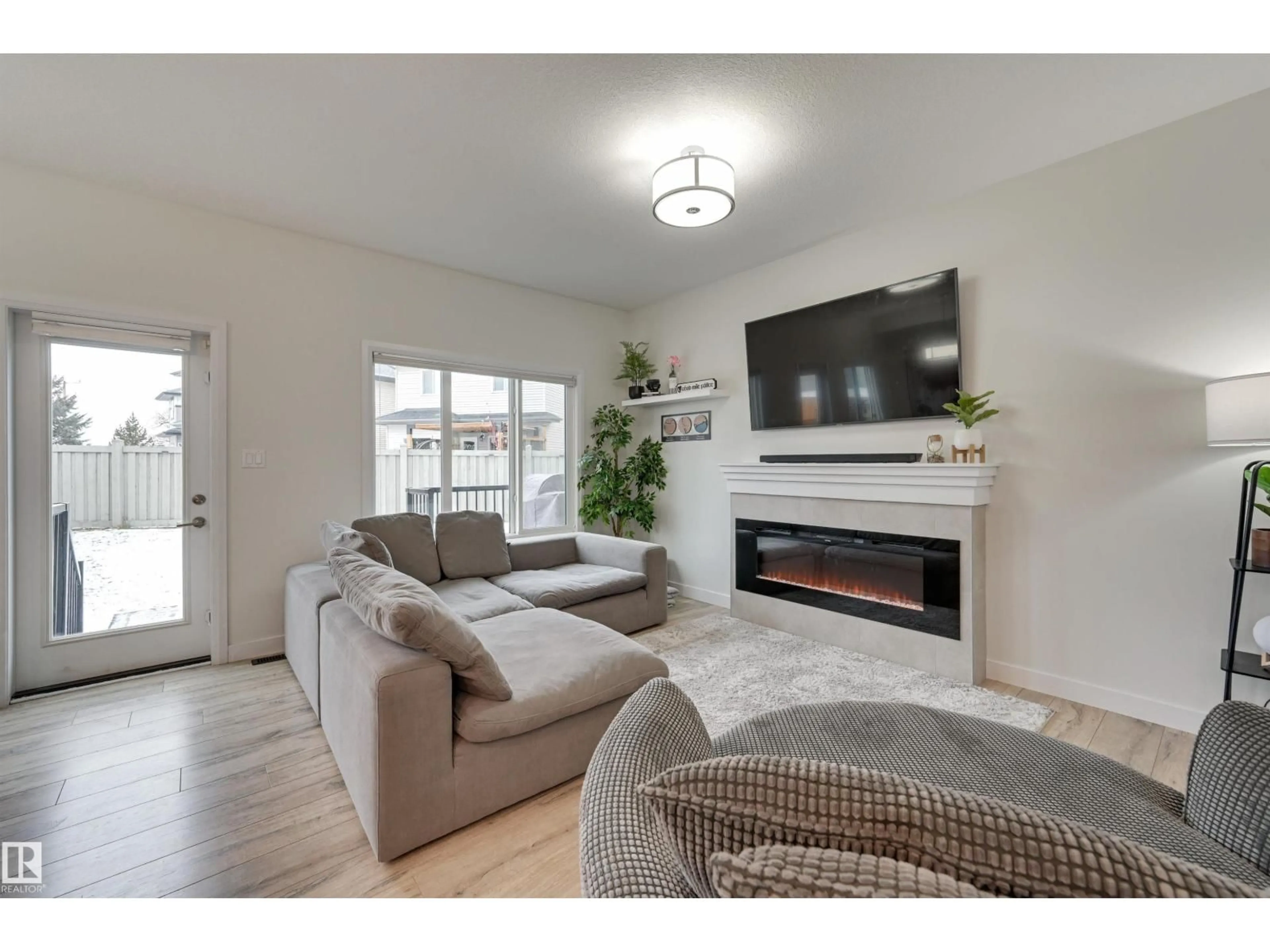 Living room with furniture, wood/laminate floor for 7234 CHIVERS PL, Edmonton Alberta T6W4L4