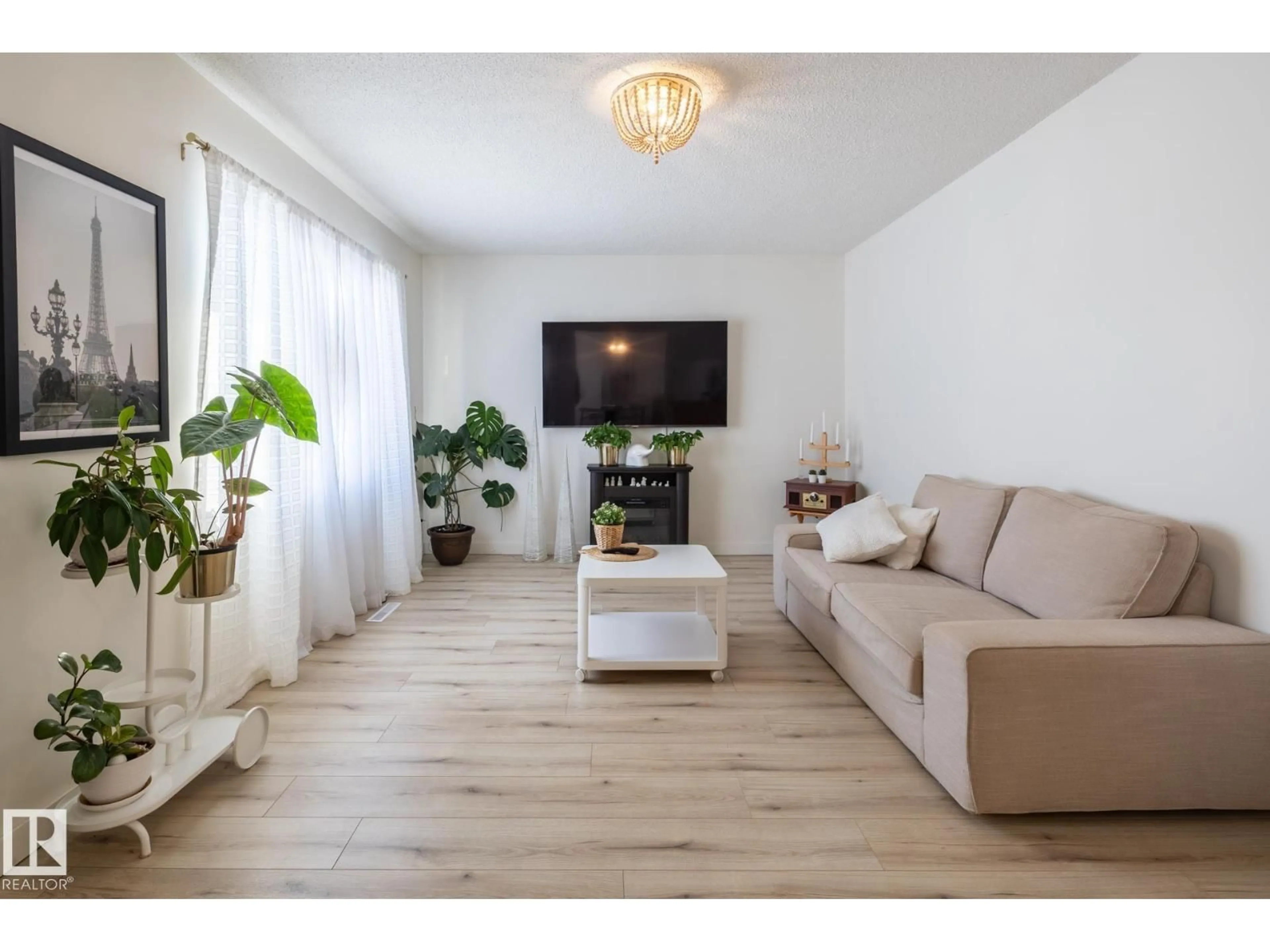 Living room with furniture, wood/laminate floor for 11502 89 ST, Edmonton Alberta T5B3T9