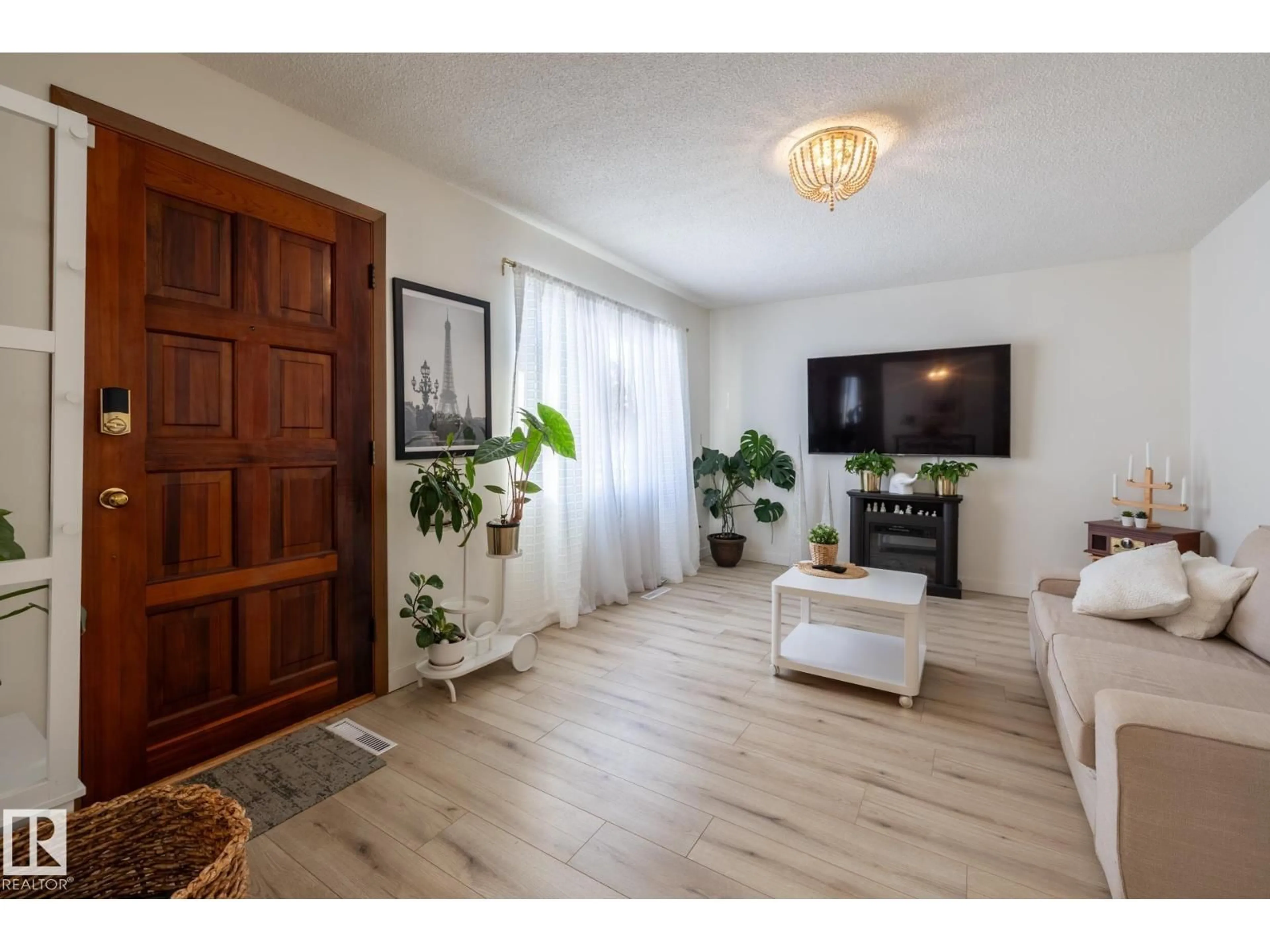 Living room with furniture, wood/laminate floor for 11502 89 ST, Edmonton Alberta T5B3T9