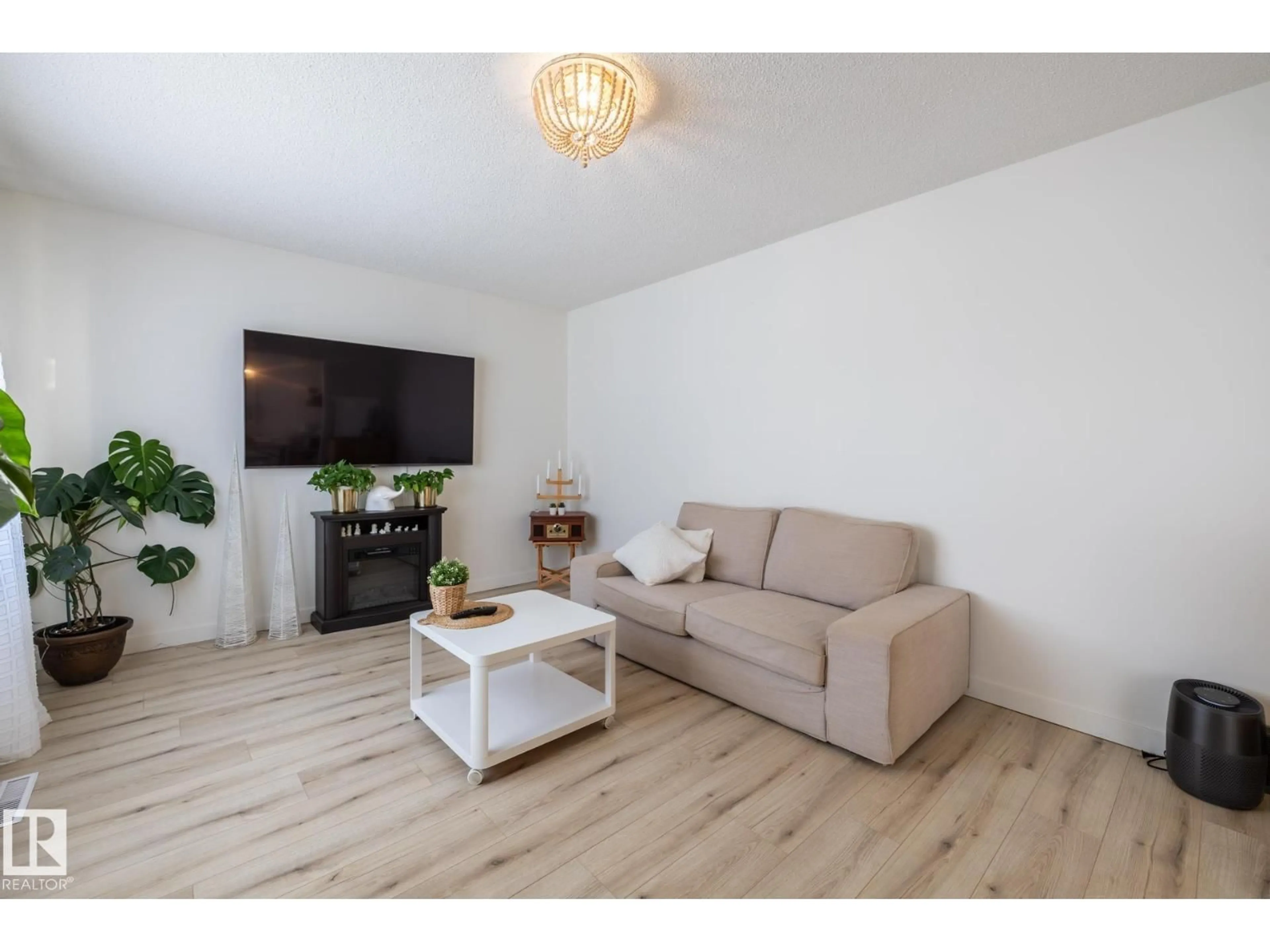 Living room with furniture, wood/laminate floor for 11502 89 ST, Edmonton Alberta T5B3T9