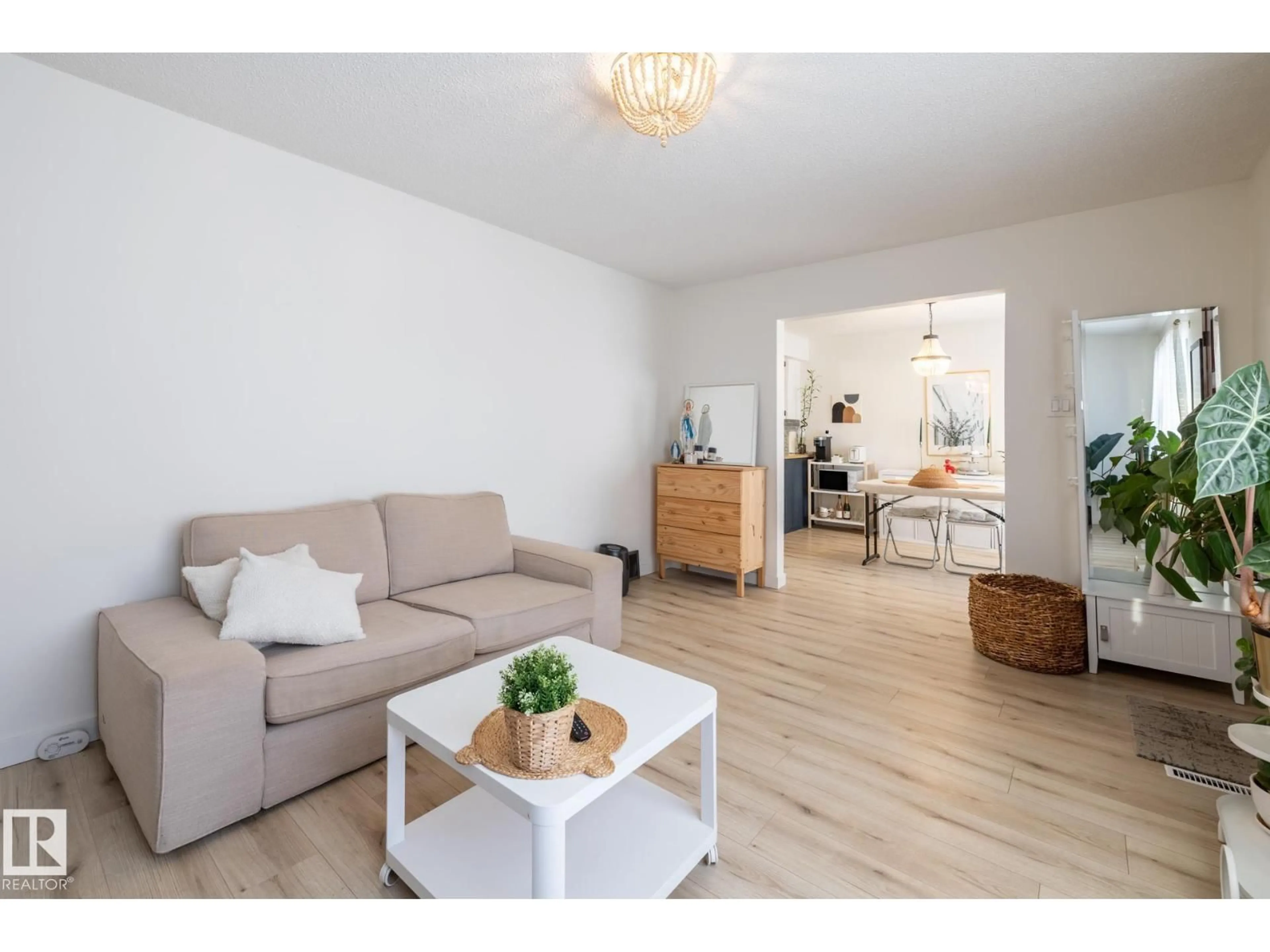 Living room with furniture, wood/laminate floor for 11502 89 ST, Edmonton Alberta T5B3T9