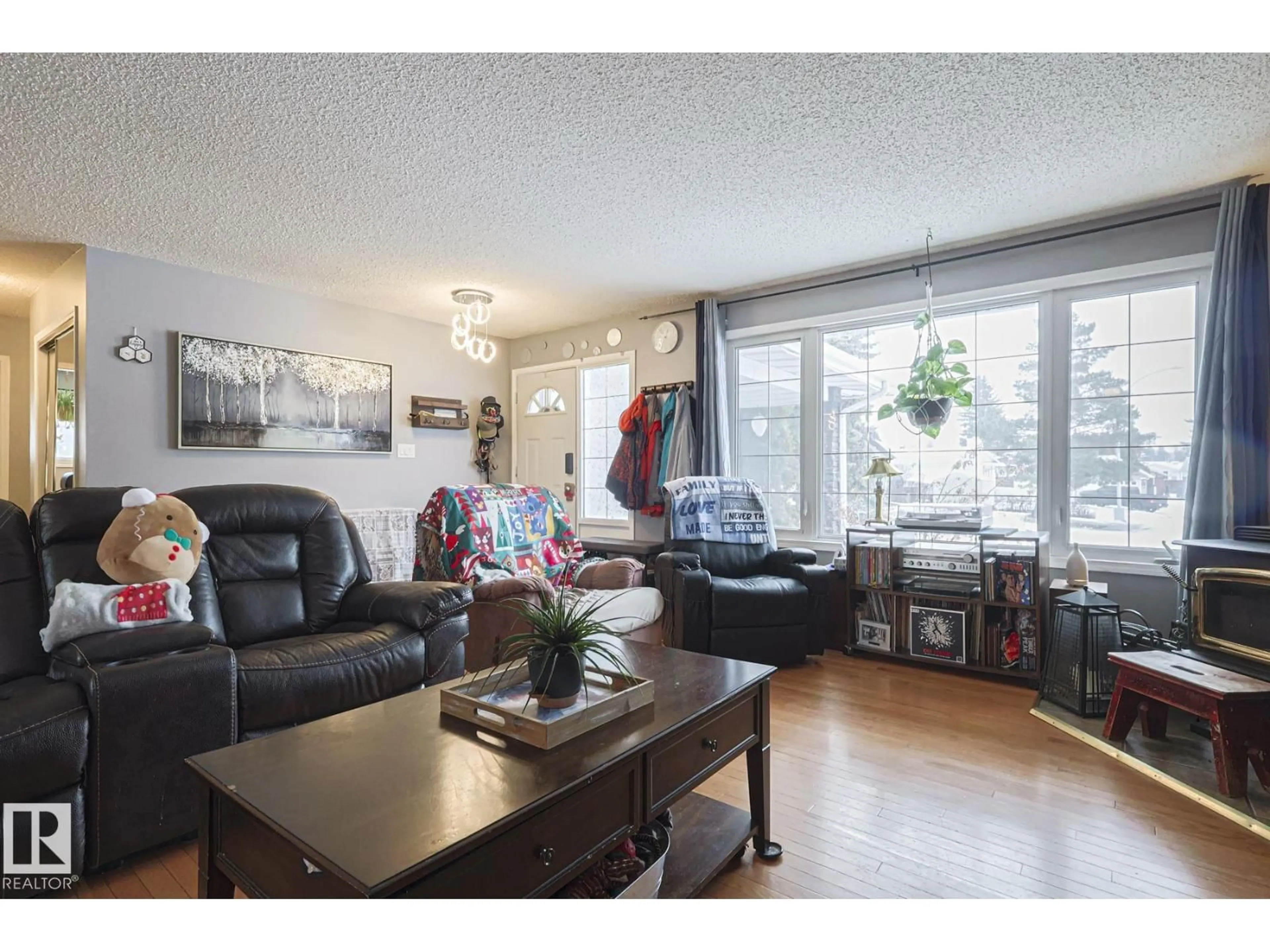 Living room with furniture, wood/laminate floor for NW - 4032 77 ST, Edmonton Alberta T6K0X6