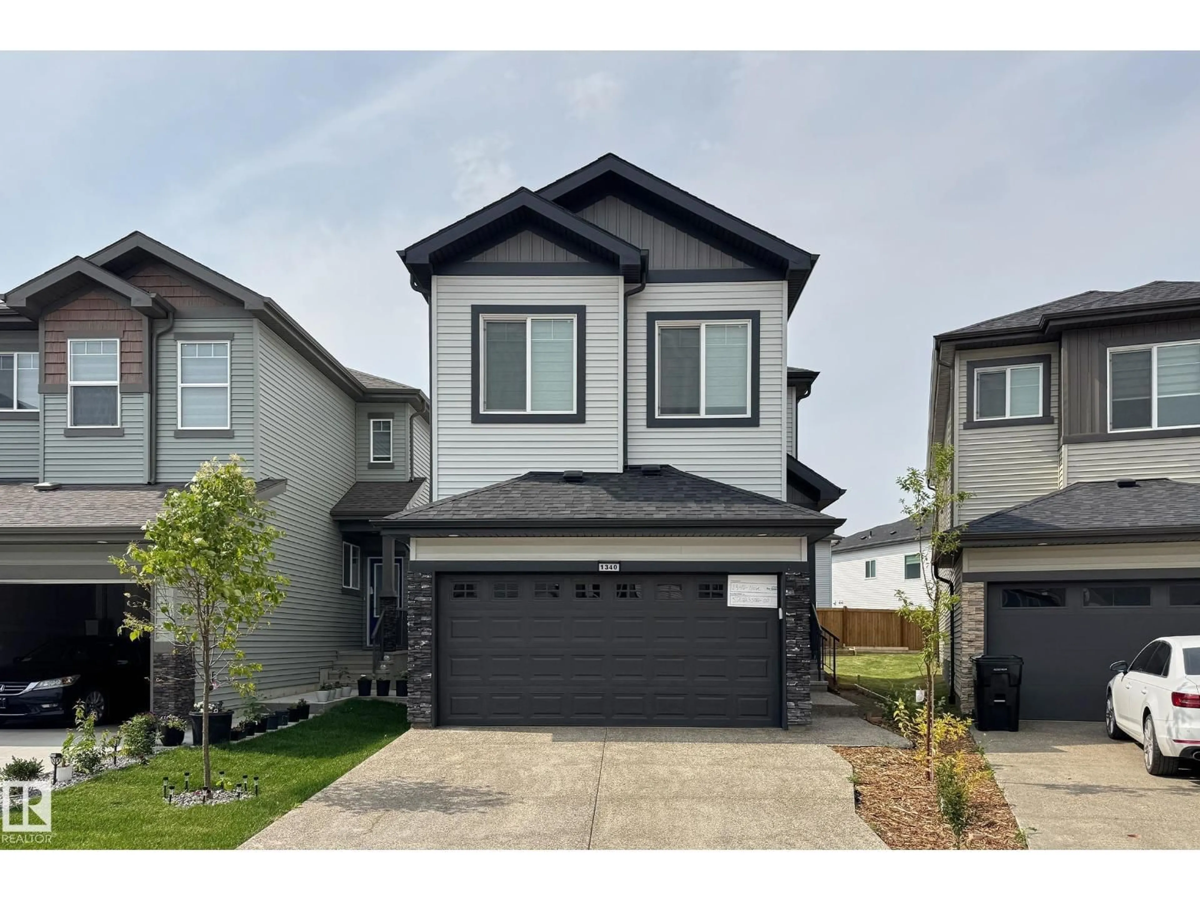Home with vinyl exterior material, street for NW - 1340 11 AV, Edmonton Alberta T6T2W4
