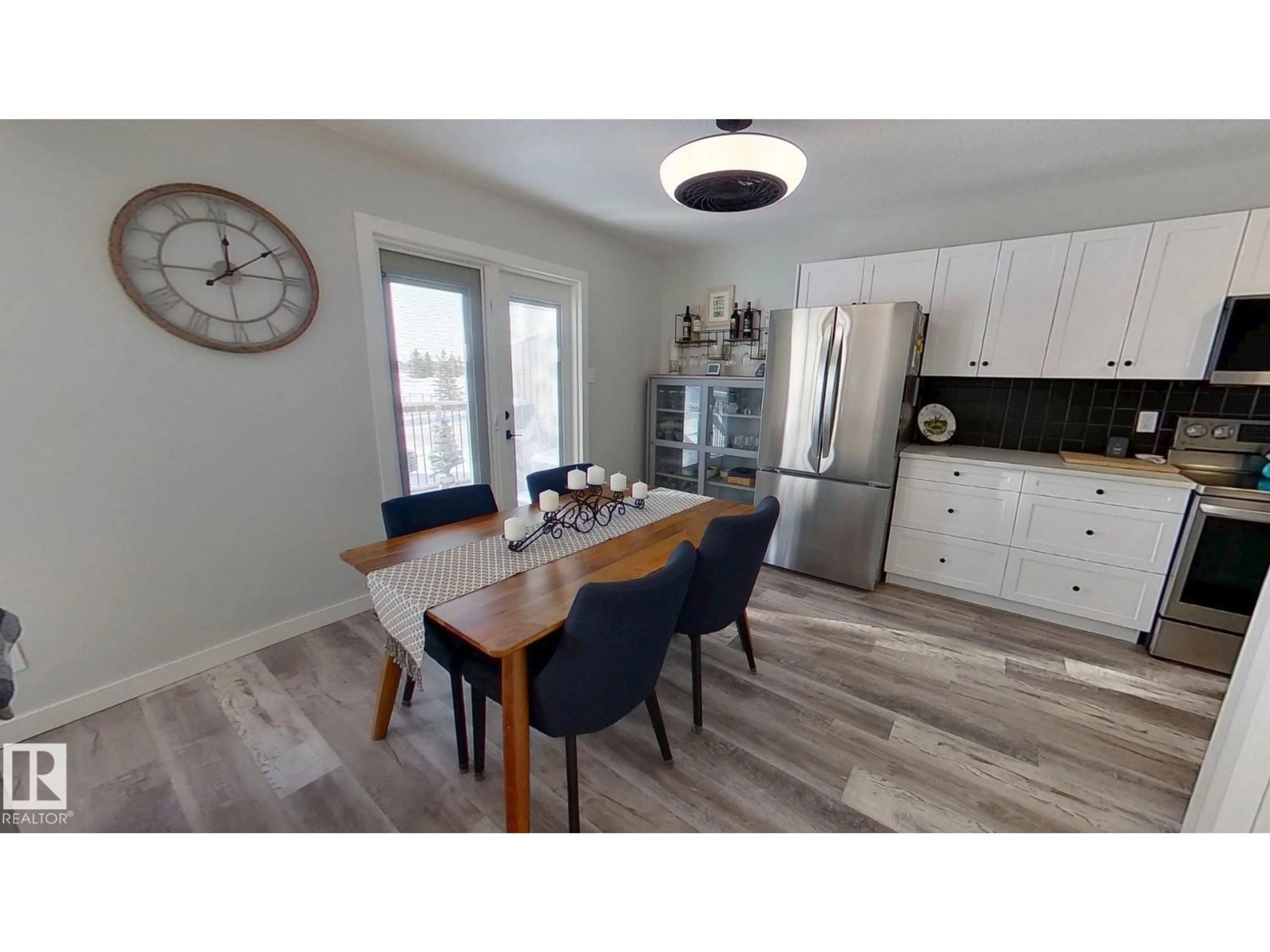 Open concept kitchen, wood/laminate floor for 7102A MARLER DR, Camrose Alberta T4V3L8