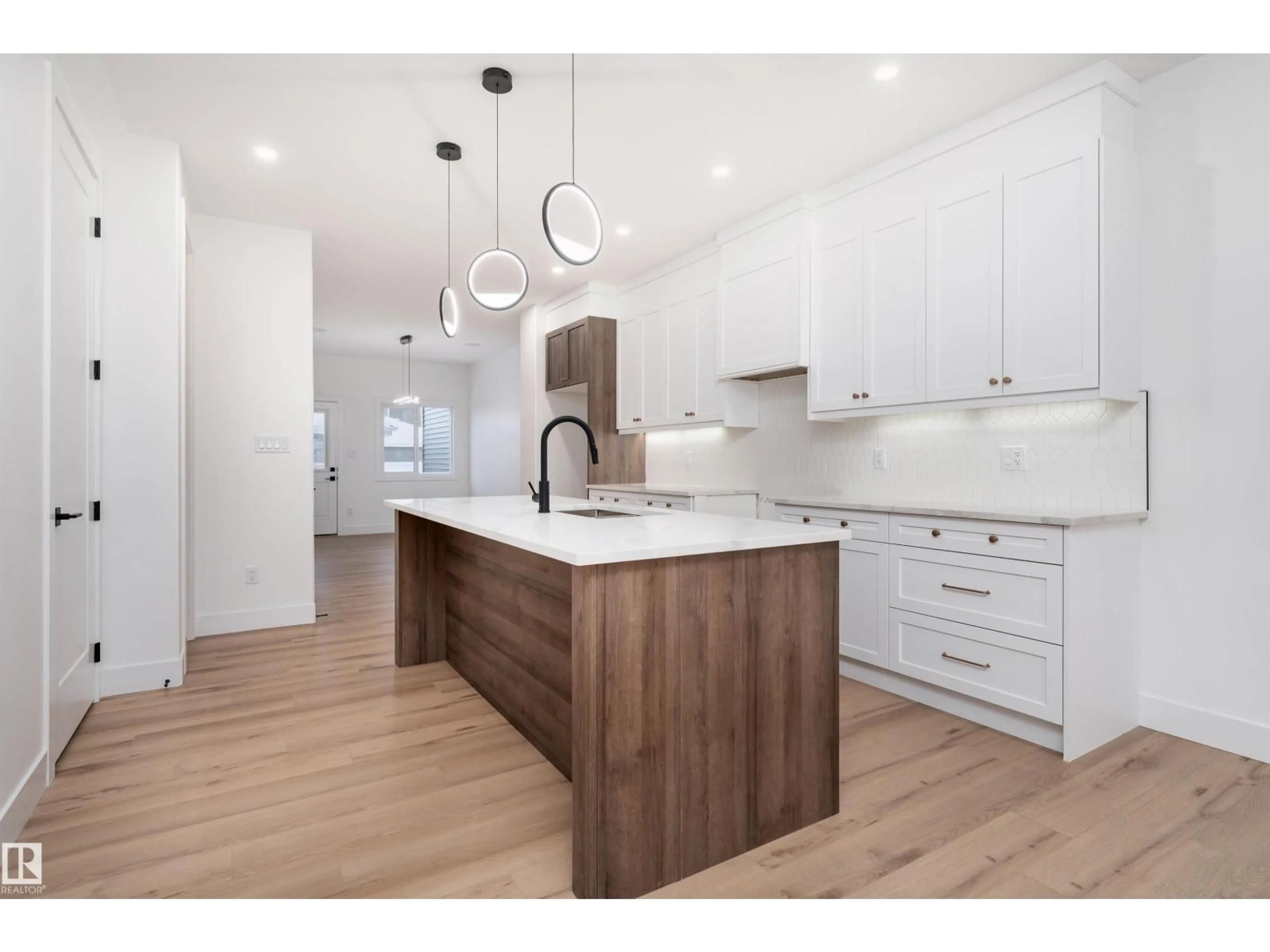 Open concept kitchen, wood/laminate floor for 3109 MAGPIE WY, Edmonton Alberta T5S0V3