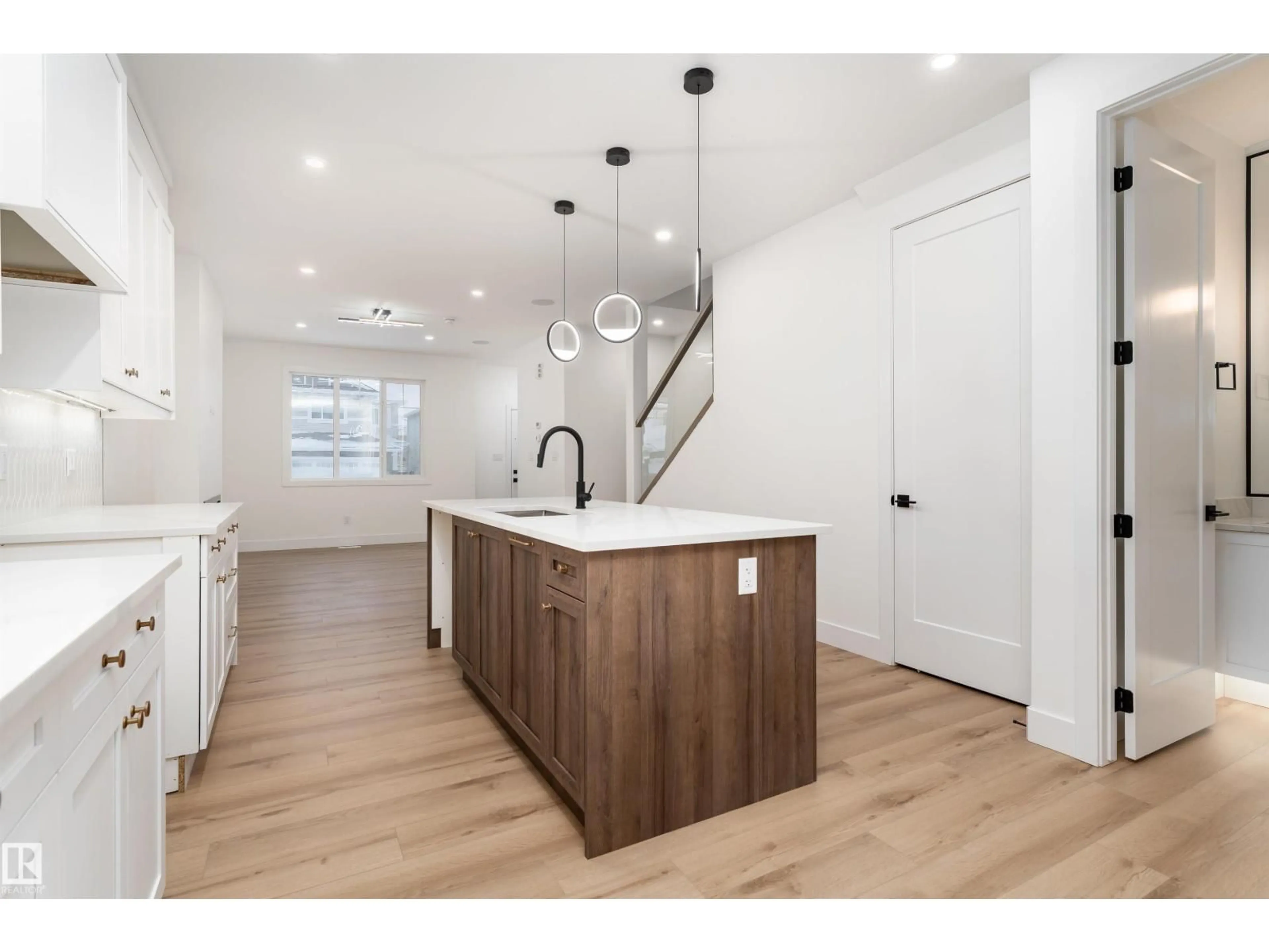 Open concept kitchen, wood/laminate floor for 3109 MAGPIE WY, Edmonton Alberta T5S0V3