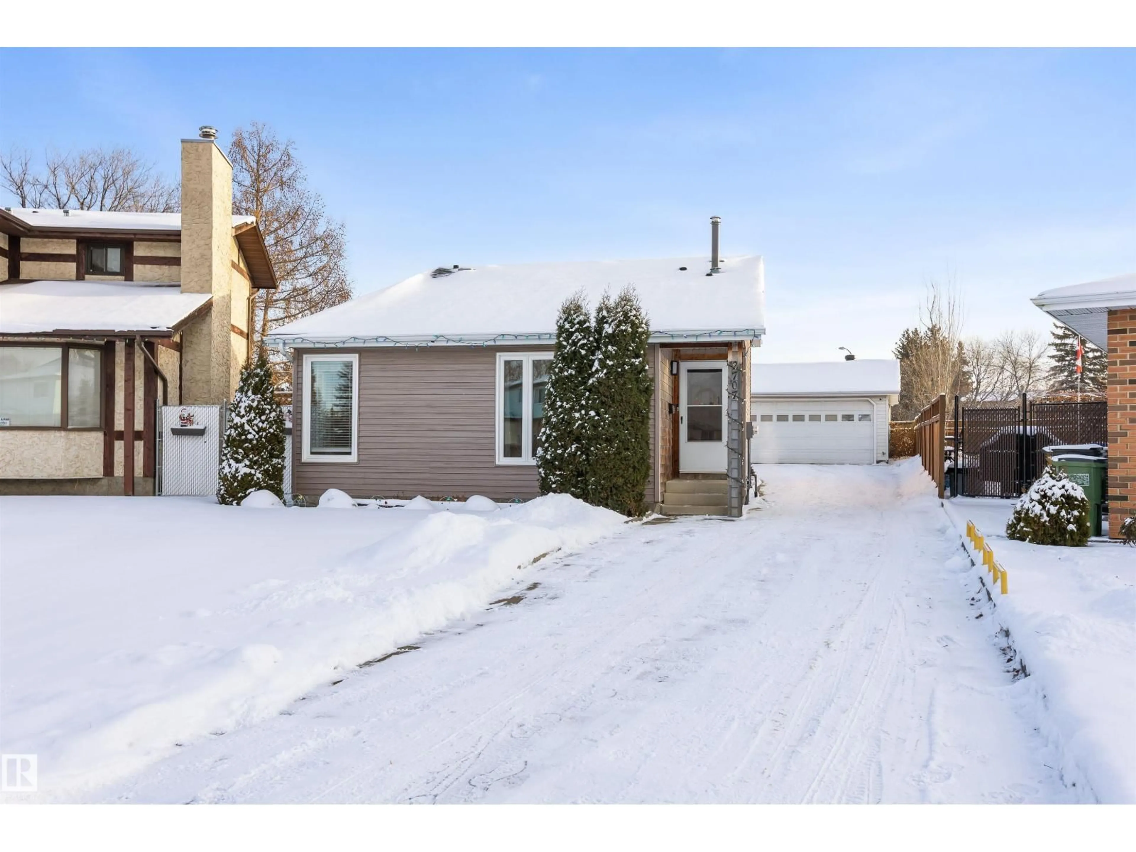 Home with vinyl exterior material, street for 2707 138 AV, Edmonton Alberta T5Y1A5