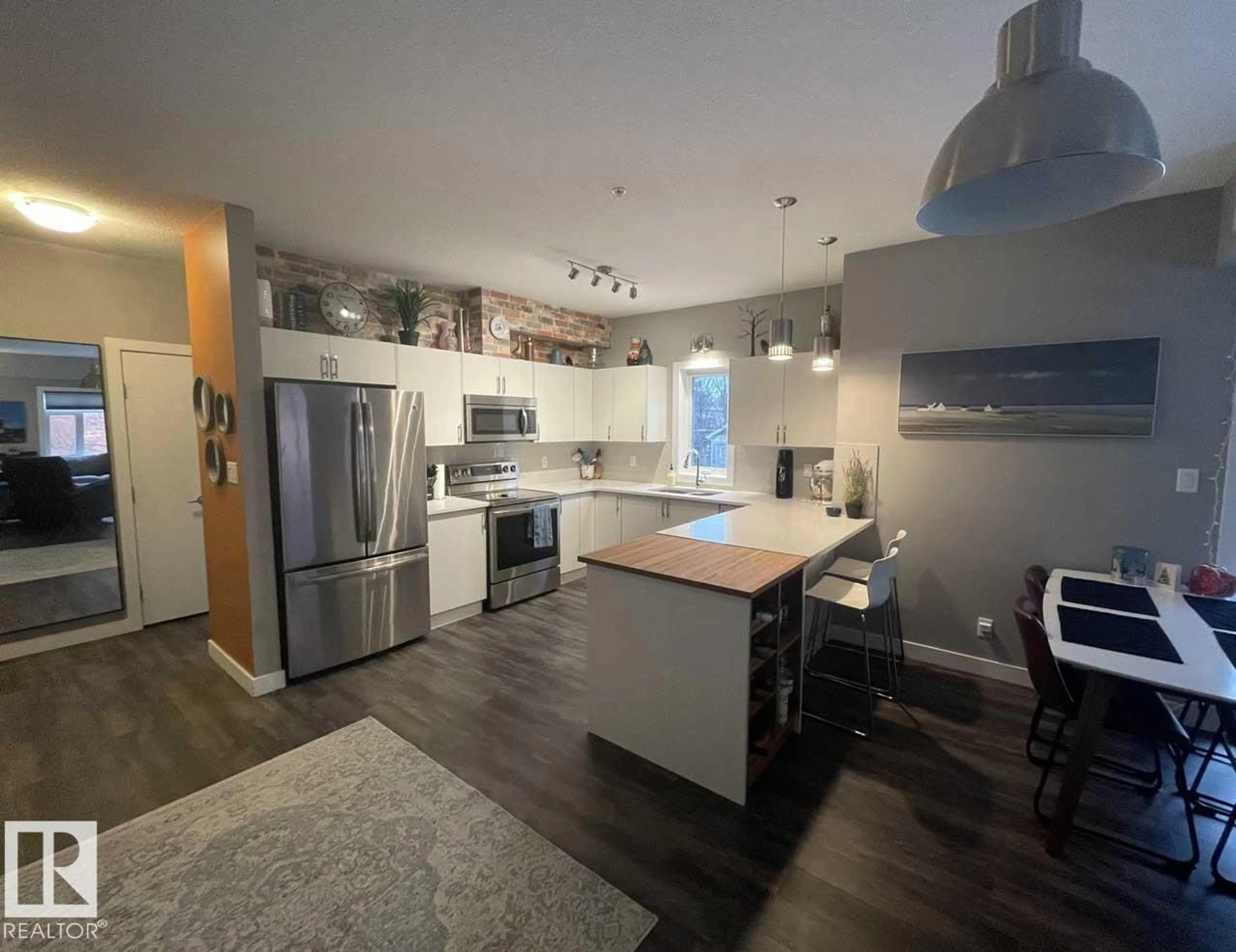 Open concept kitchen, wood/laminate floor for 200 - 8525 91 ST, Edmonton Alberta T6C3N1