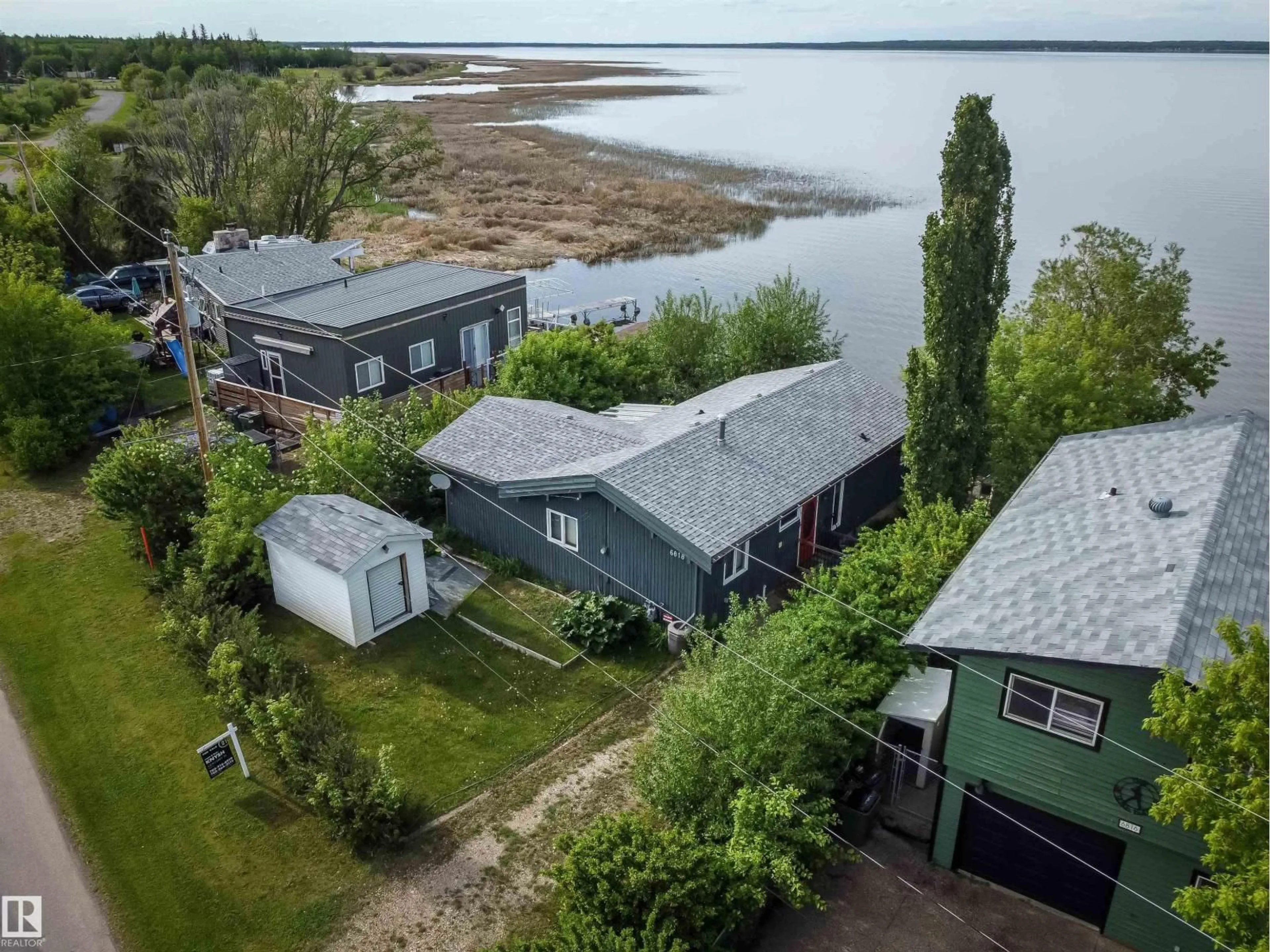 A pic from outside/outdoor area/front of a property/back of a property/a pic from drone, water/lake/river/ocean view for 6818 50 AV, Rural Lac Ste. Anne County Alberta T0E0A0