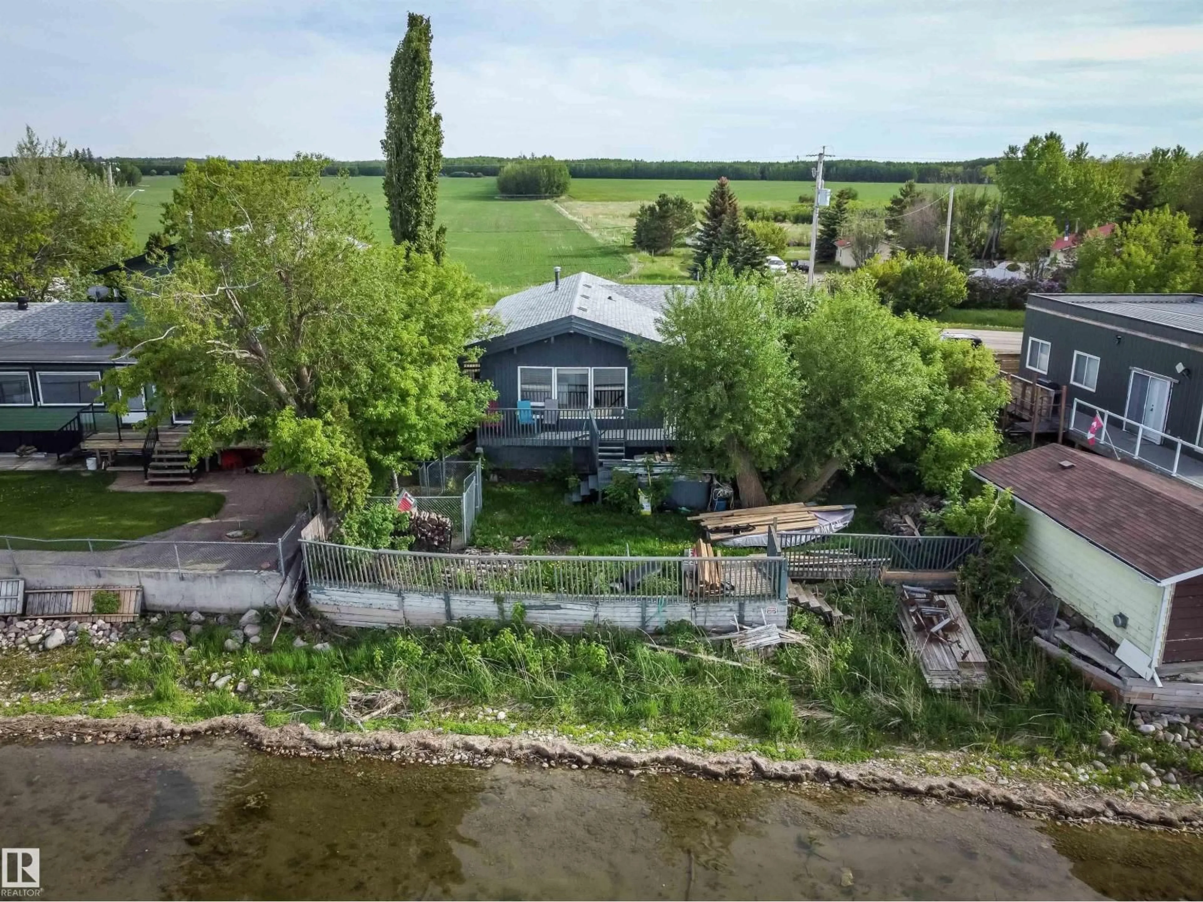 A pic from outside/outdoor area/front of a property/back of a property/a pic from drone, water/lake/river/ocean view for 6818 50 AV, Rural Lac Ste. Anne County Alberta T0E0A0
