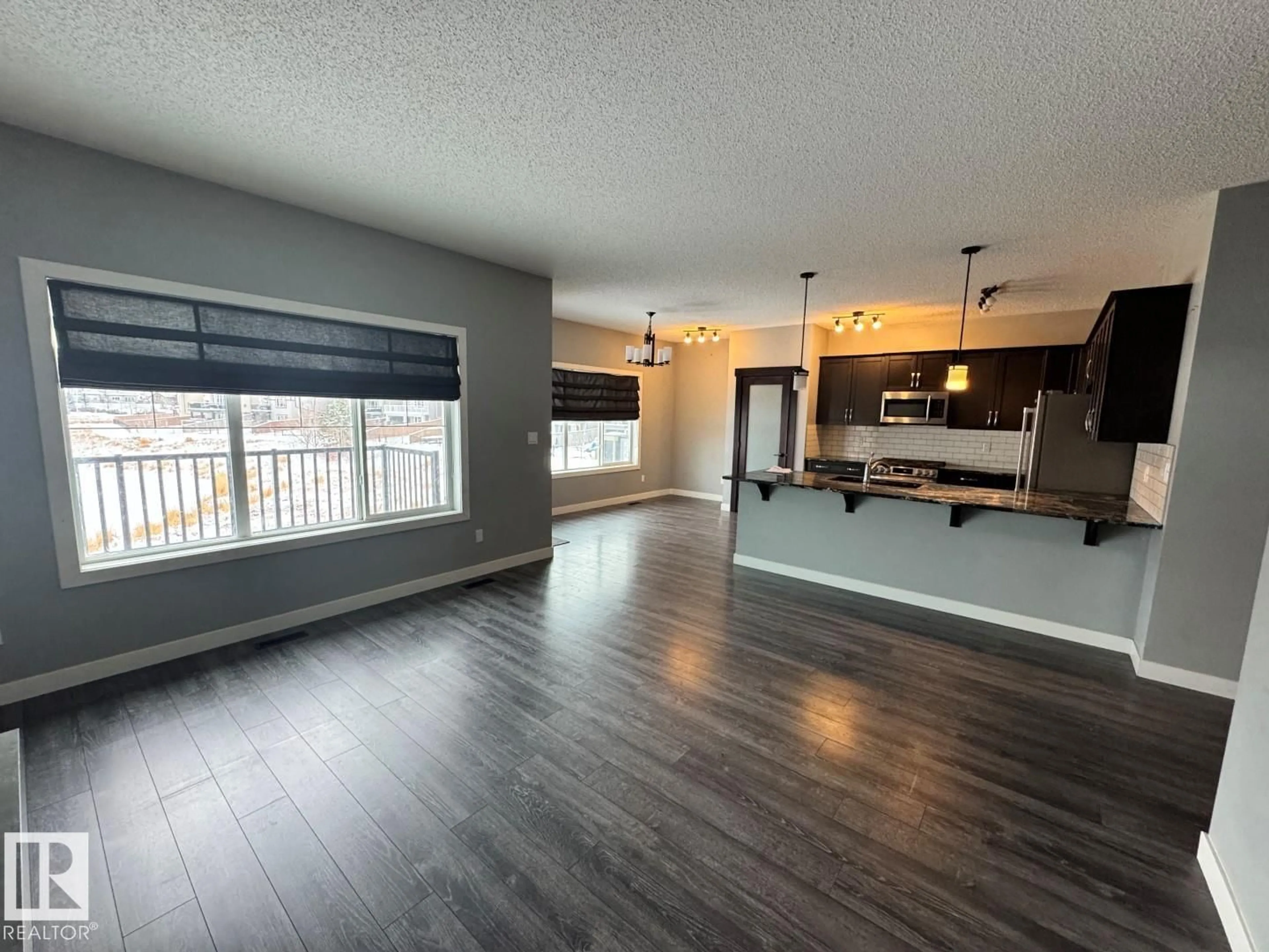 Open concept kitchen, wood/laminate floor for 1352 SECORD LANDING LD, Edmonton Alberta T5T5W7