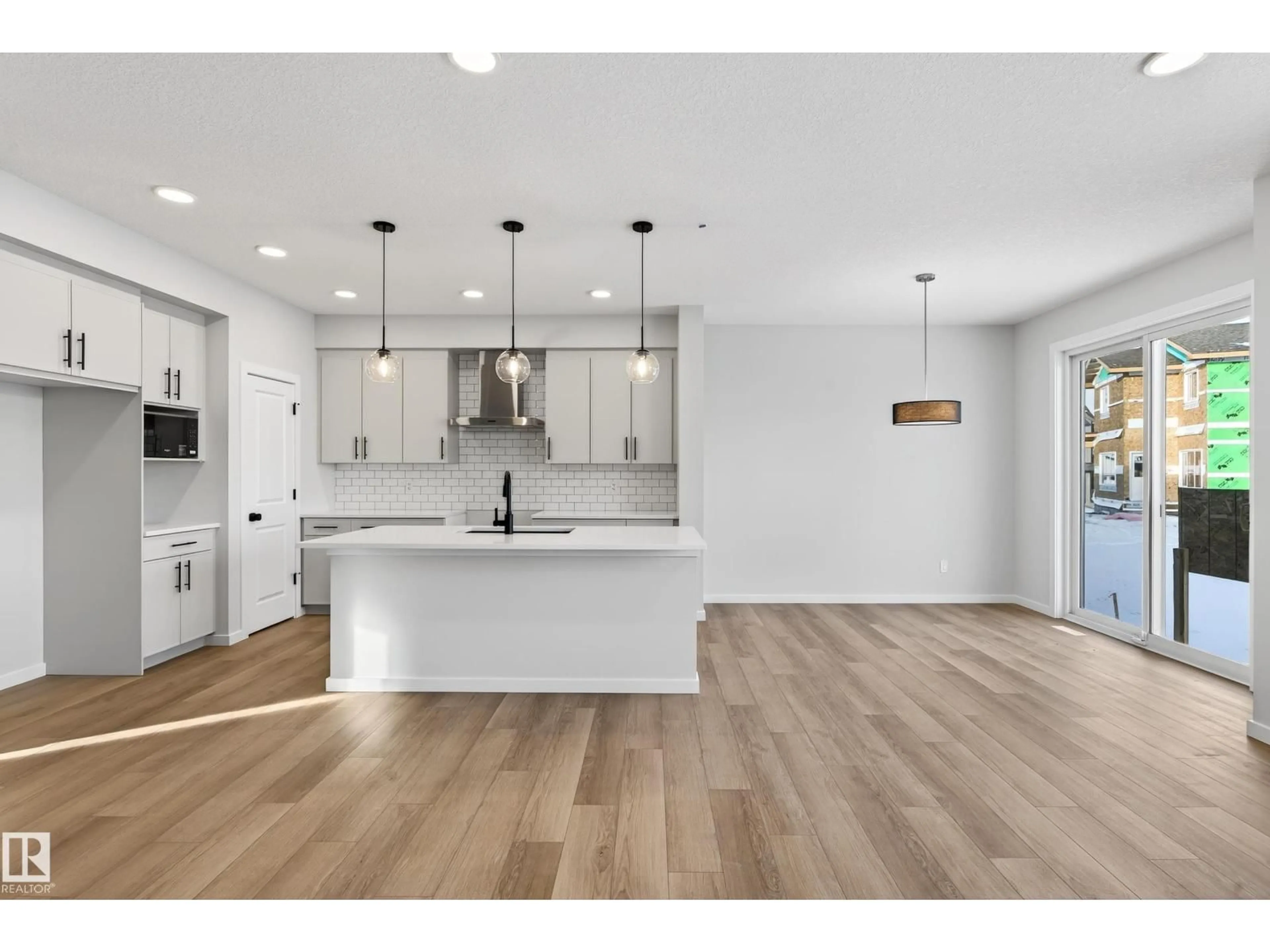 Open concept kitchen, wood/laminate floor for 2251 194 ST, Edmonton Alberta T6M3B7