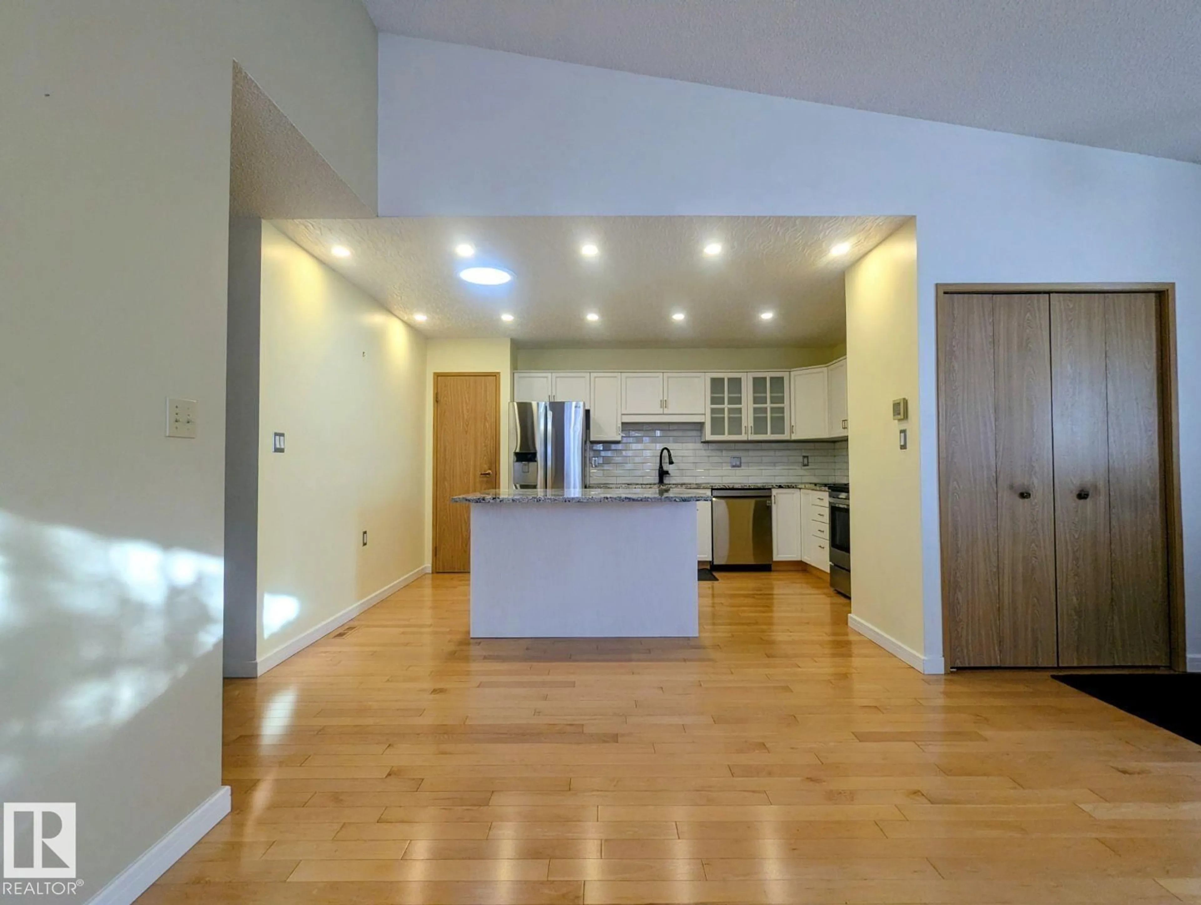 Open concept kitchen, wood/laminate floor for 7540 137A AV, Edmonton Alberta T5C3R4