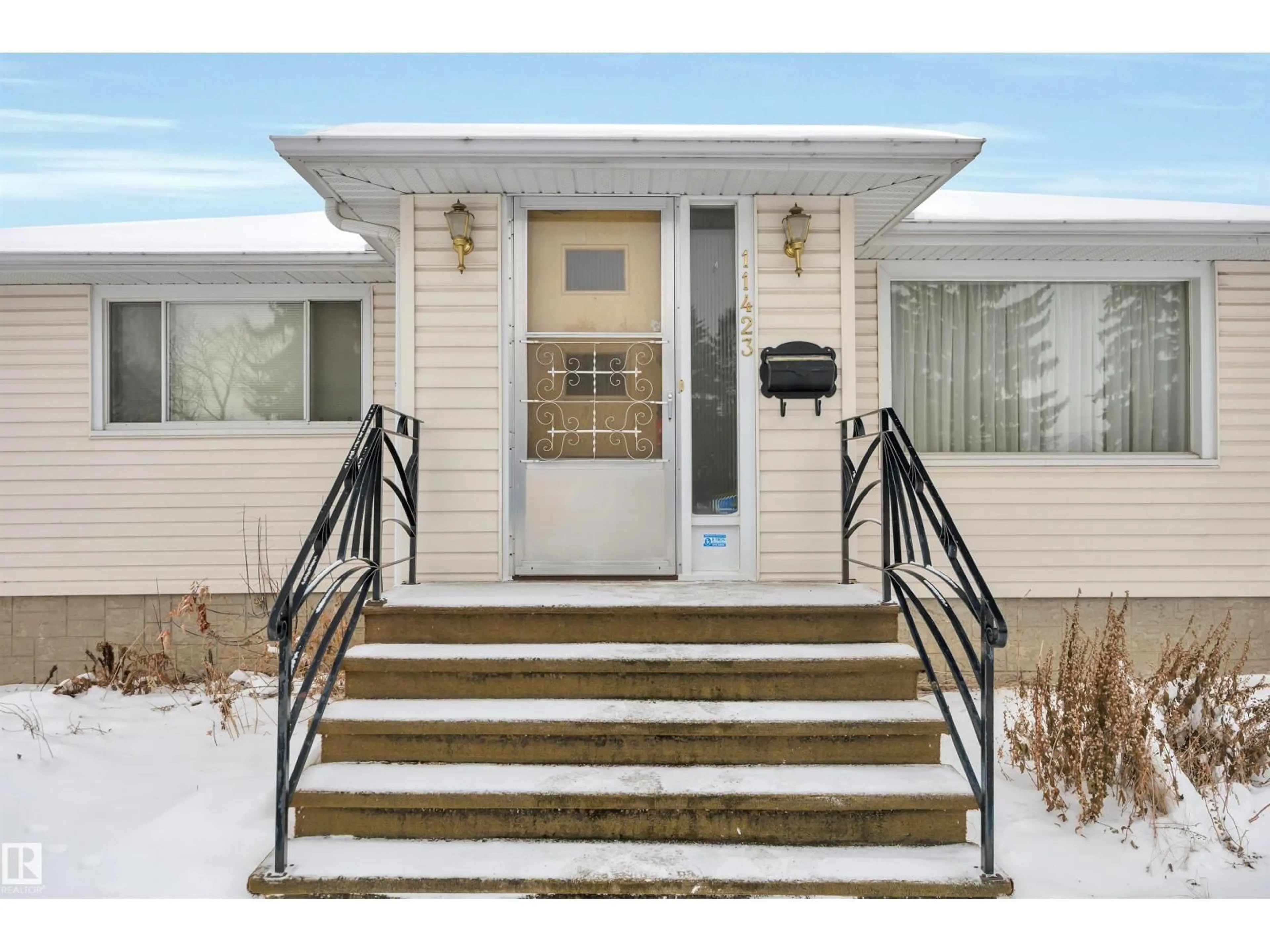 Home with vinyl exterior material, street for 11423 112 AV, Edmonton Alberta T5G0H5