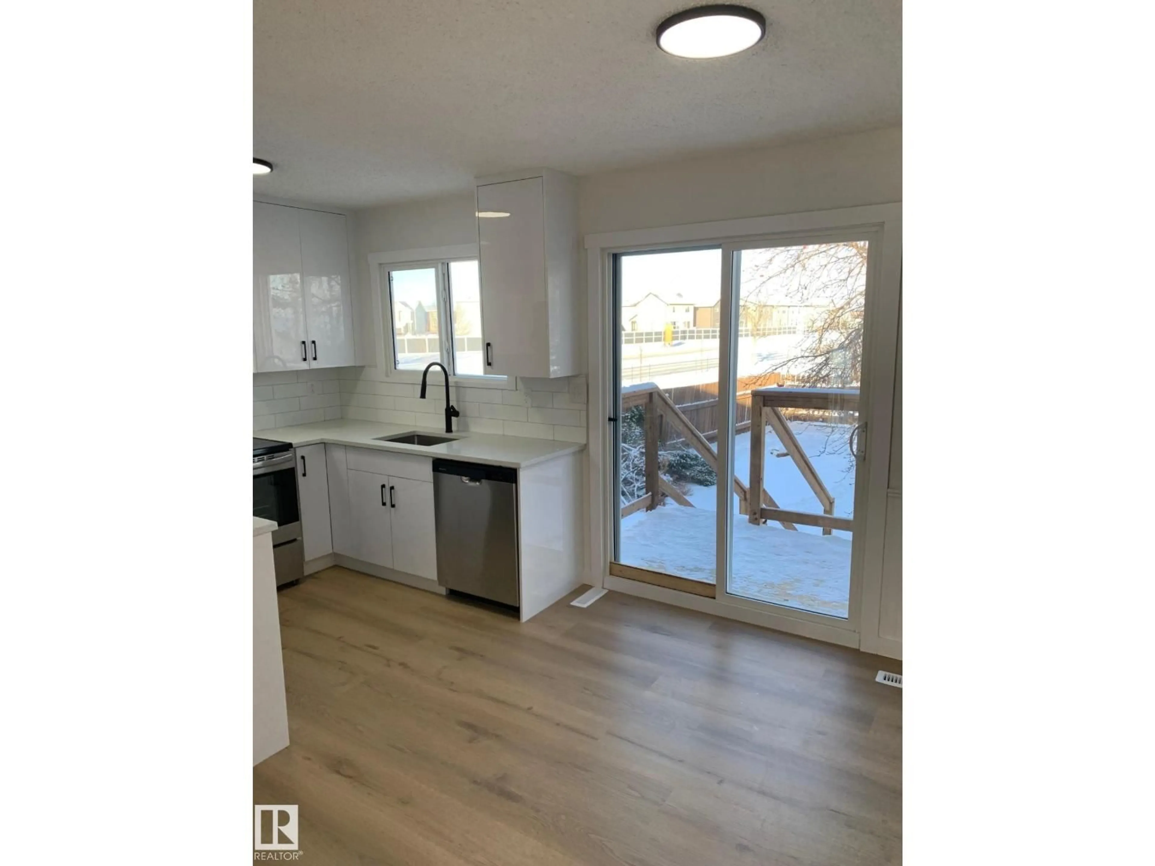 Open concept kitchen, wood/laminate floor for NW - 2618 151 AV, Edmonton Alberta T5Y1Z3
