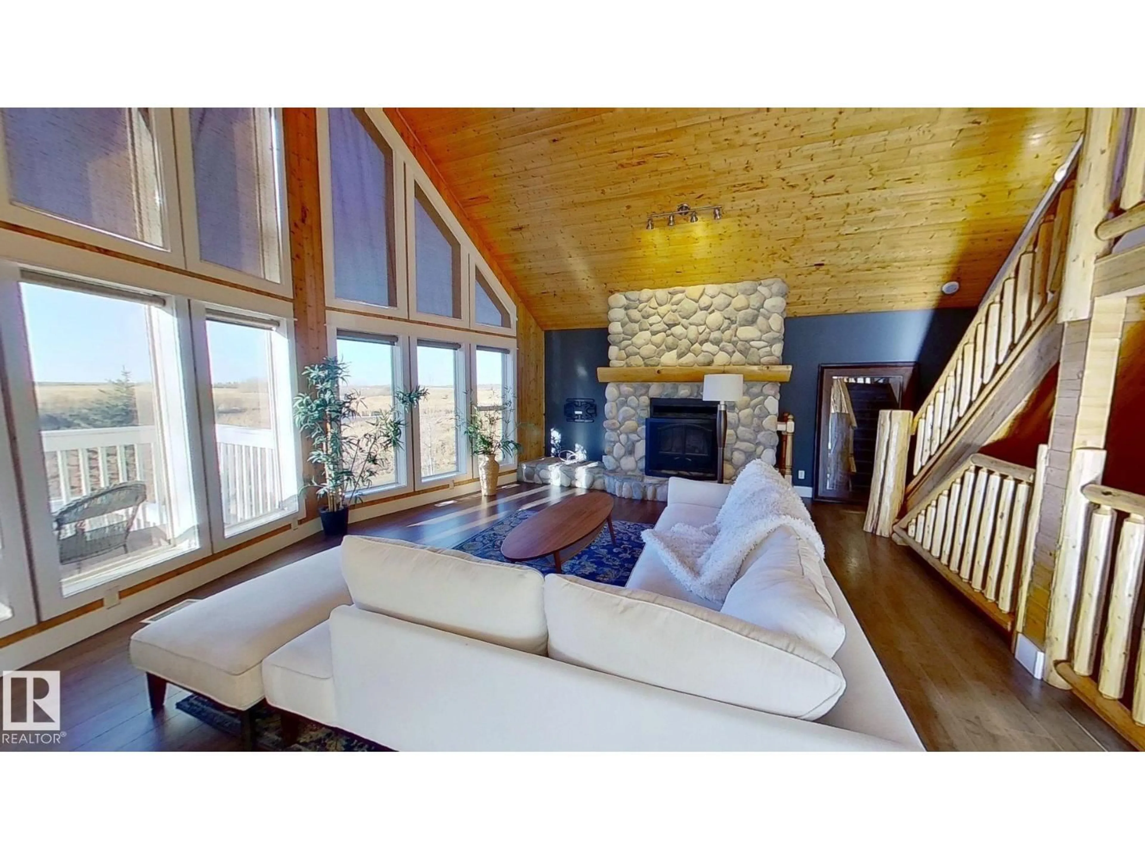 Living room with furniture, wood/laminate floor for 120 50434 RGE RD 232, Rural Leduc County Alberta T4X0L1