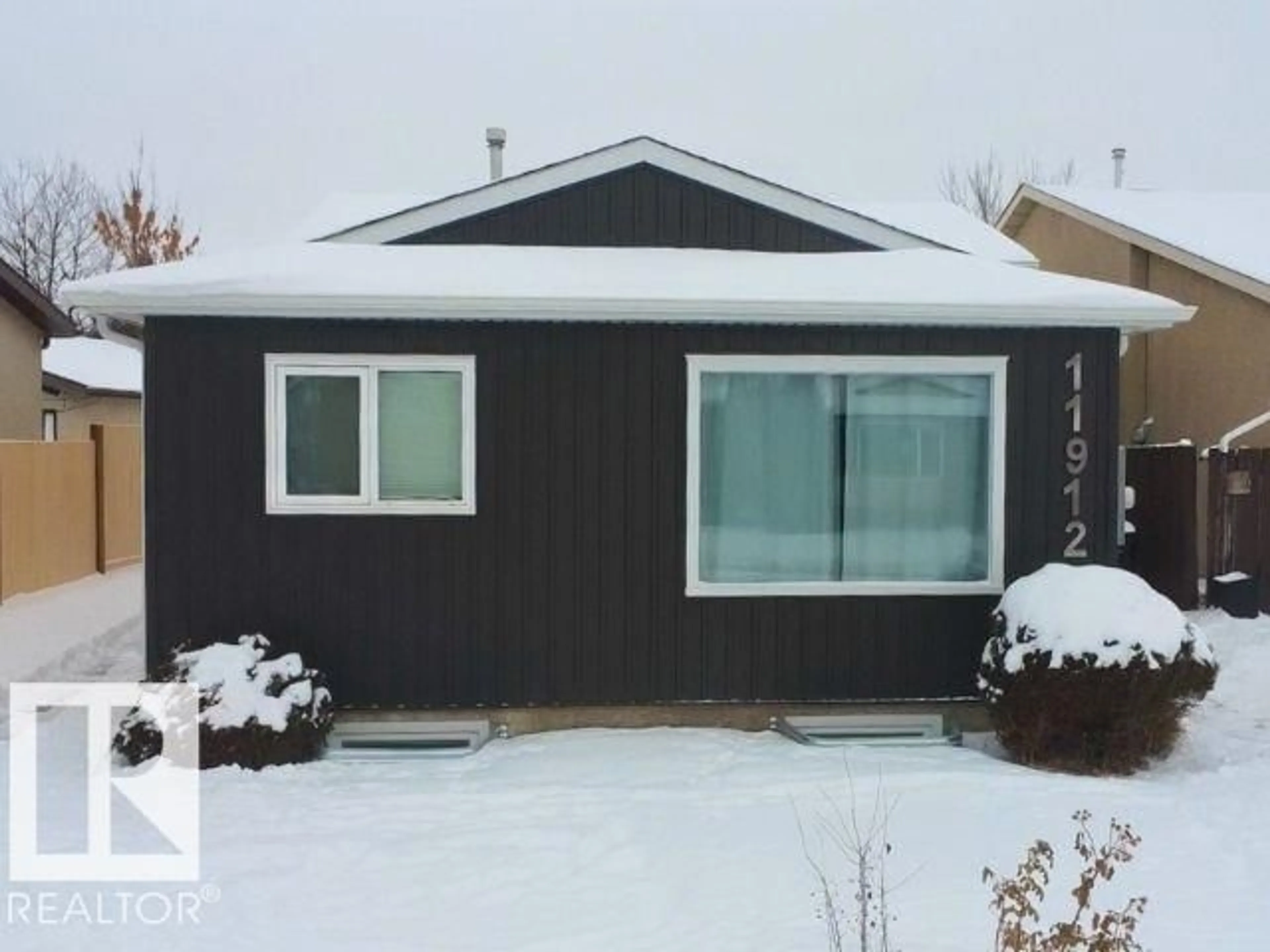 Home with vinyl exterior material, street for 11912 140 AV, Edmonton Alberta T5X5K1