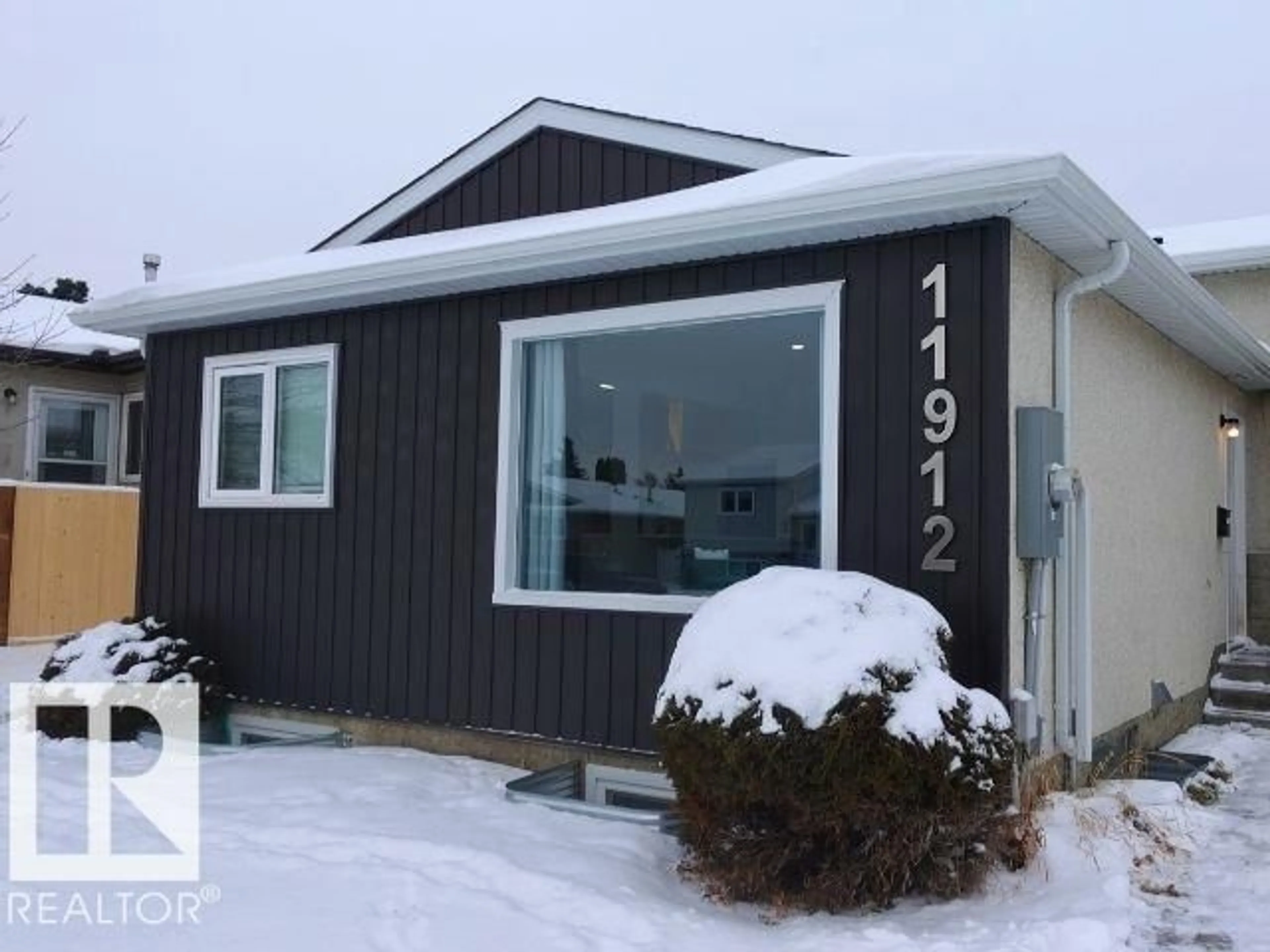 Home with vinyl exterior material, street for 11912 140 AV, Edmonton Alberta T5X5K1