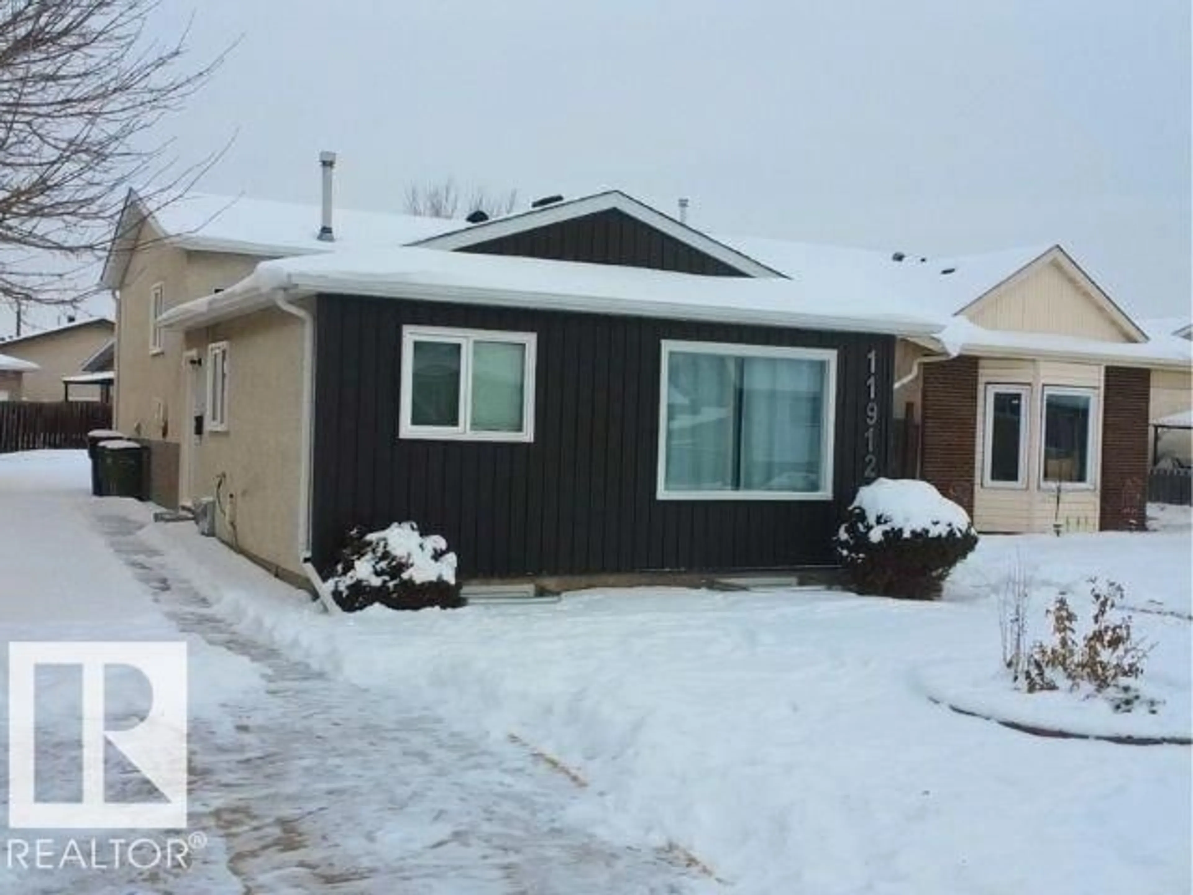 Home with vinyl exterior material, street for 11912 140 AV, Edmonton Alberta T5X5K1